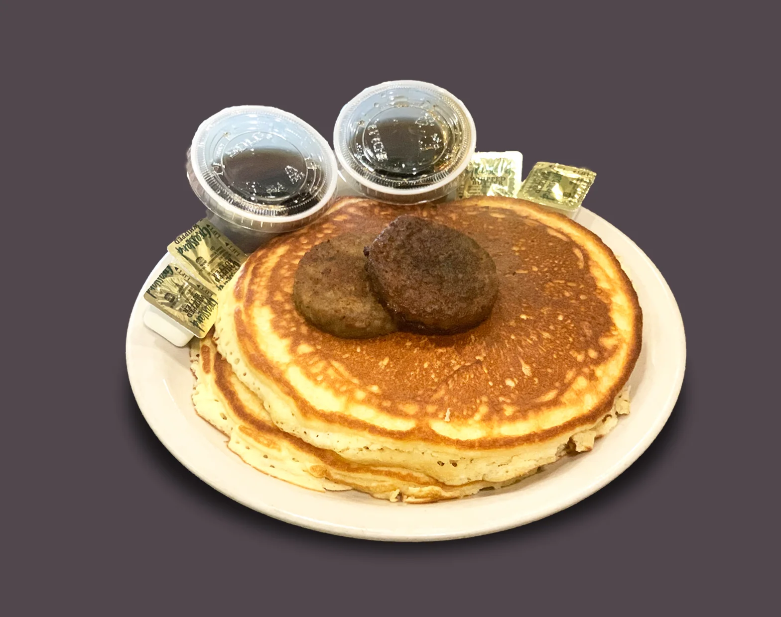 Fluffy buttermilk pancakes with sausage and syrup