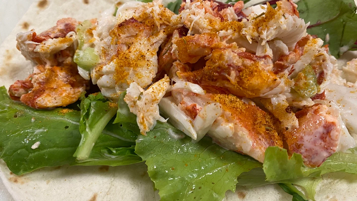 Lobster roll with fresh greens in a tortilla wrap