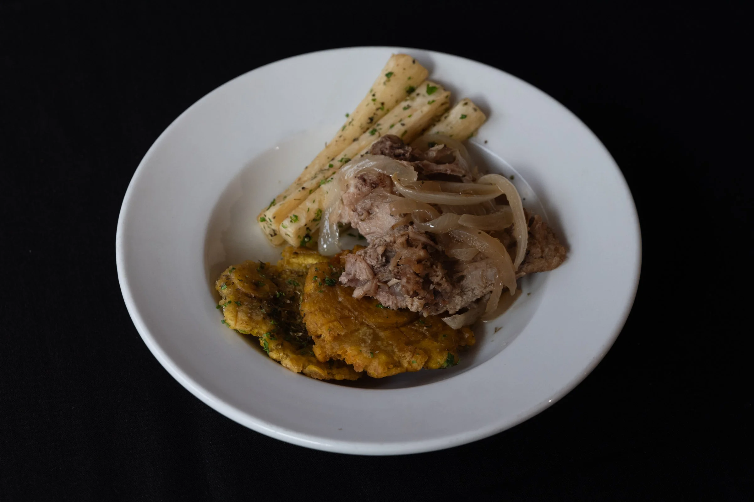 Puerto Rican lechón with tostones and yuca