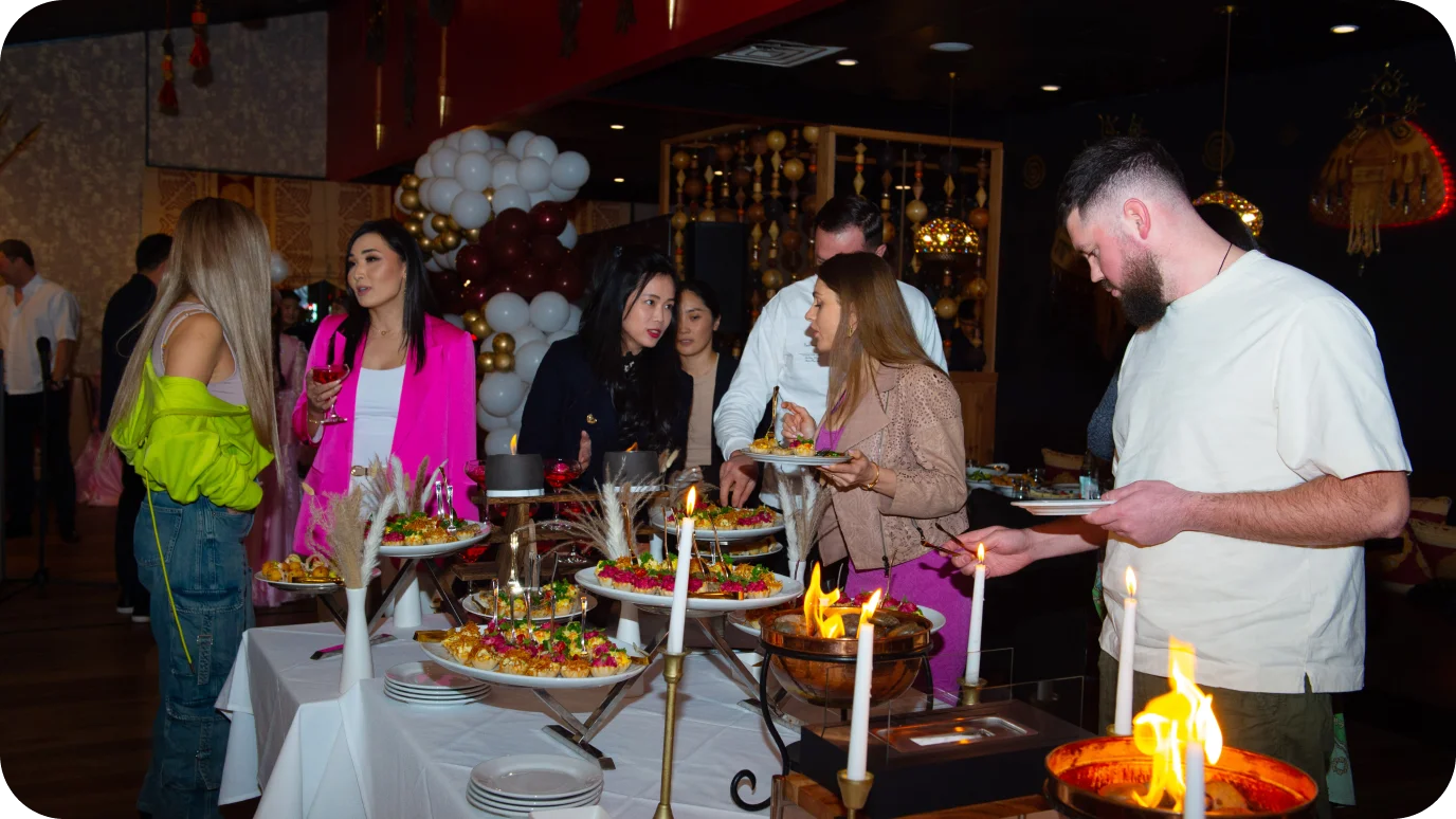 Elegant buffet setup with diverse dishes and guests enjoying a festive atmosphere