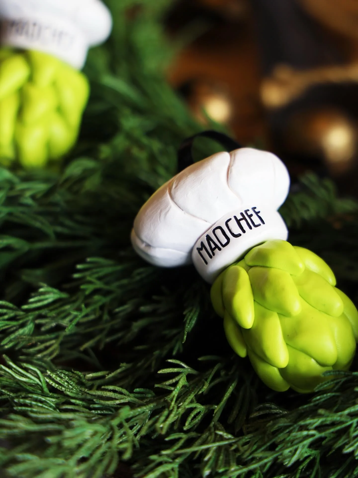 Chef hat and asparagus figurines on greenery