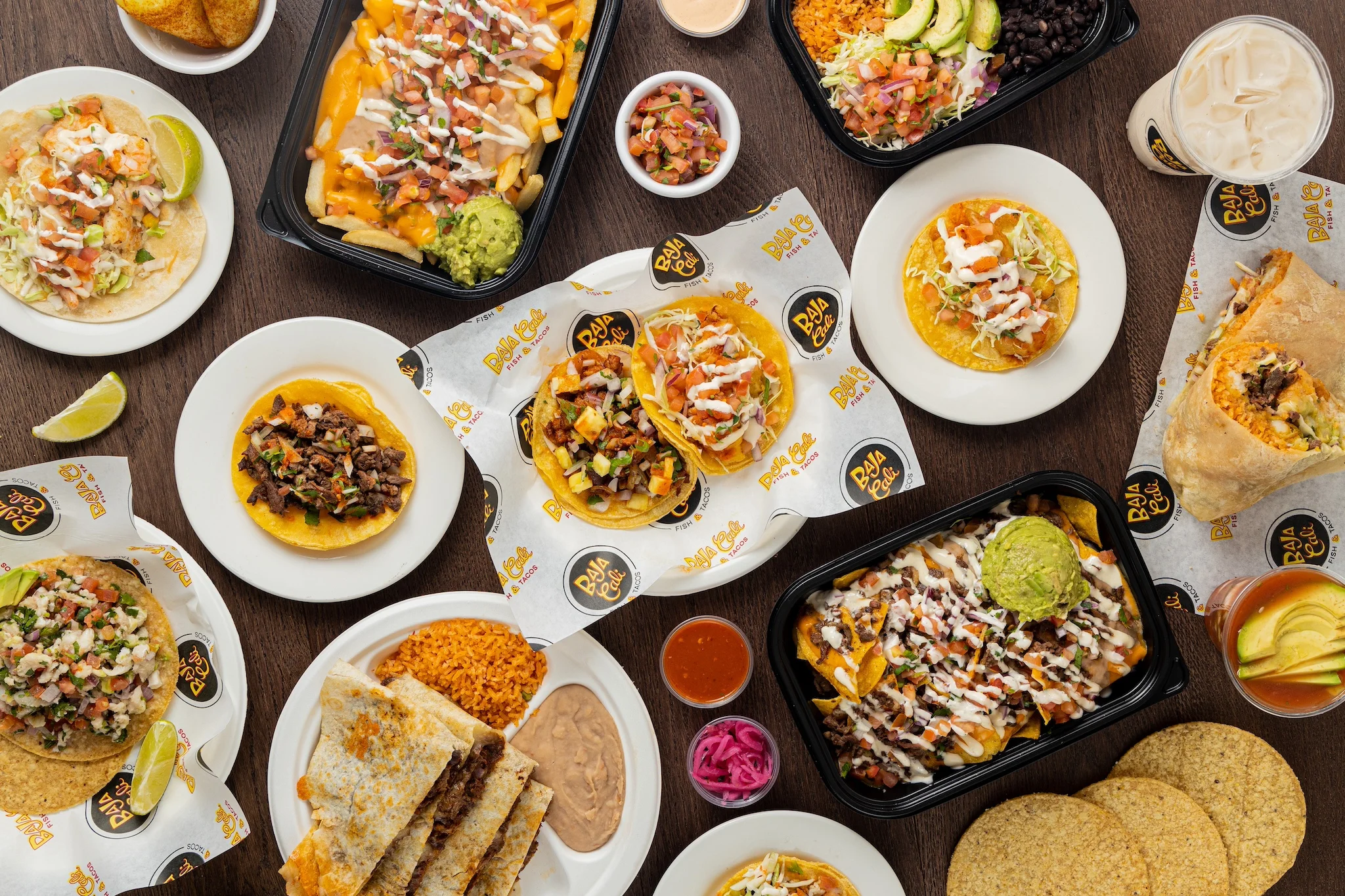 Assorted Mexican tacos and nachos with guacamole and toppings