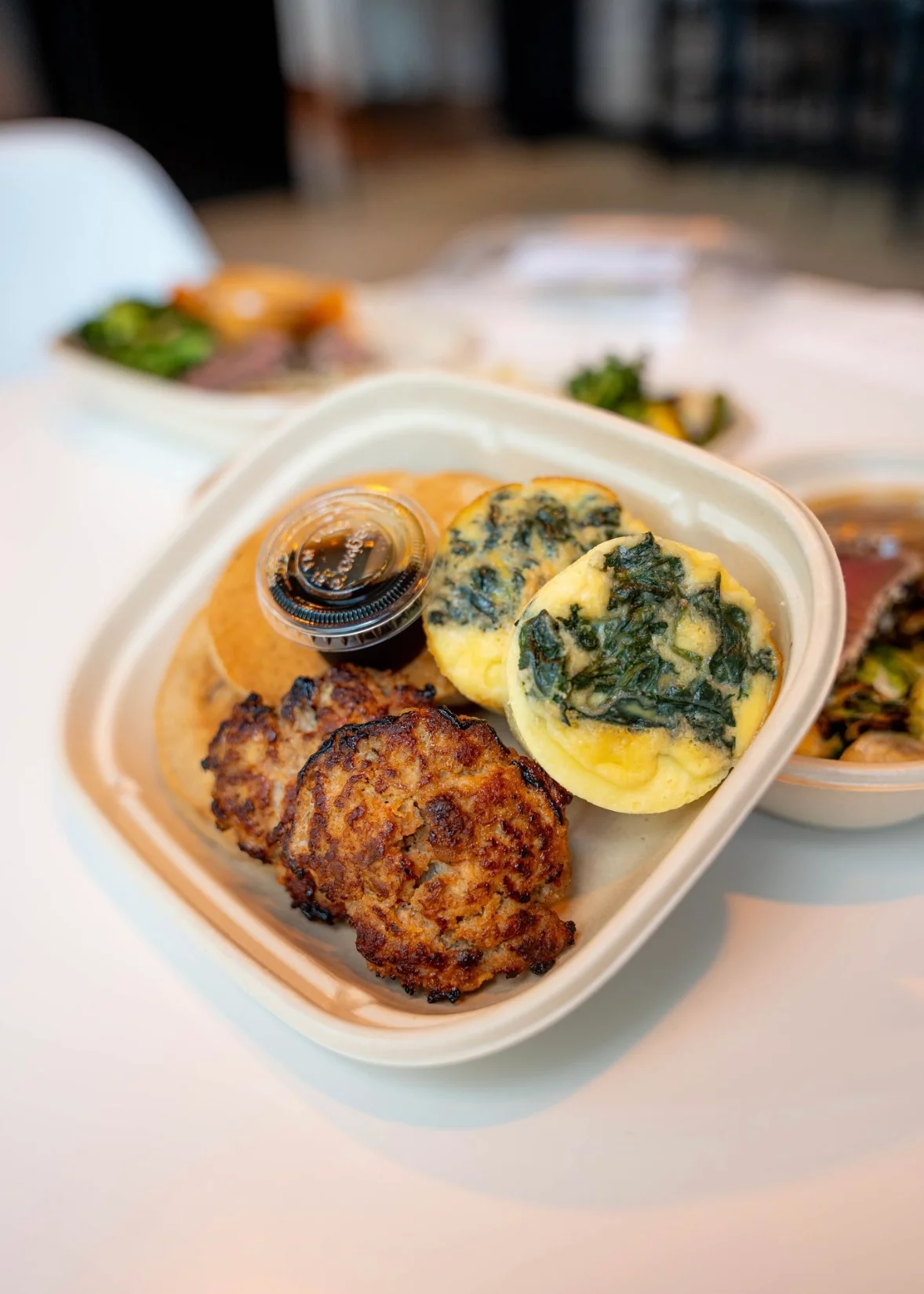 Savory breakfast platter with spinach frittatas and sausage patties
