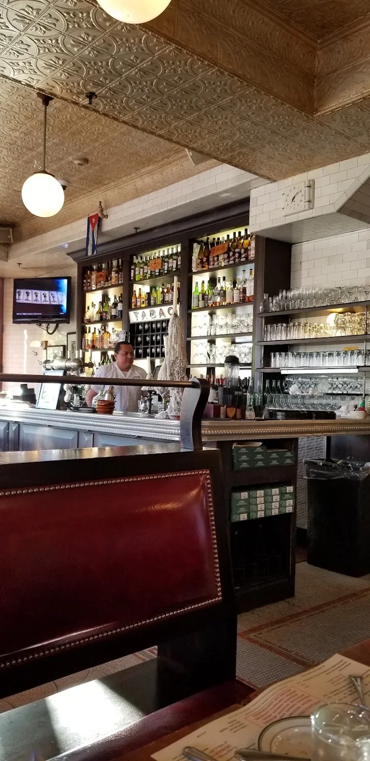 Cozy bar interior with a well-stocked liquor display and warm lighting