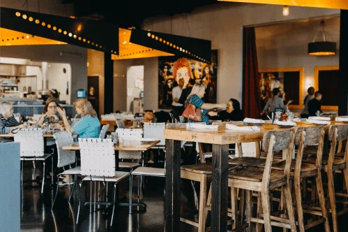Modern restaurant interior with wooden seating and vibrant decor