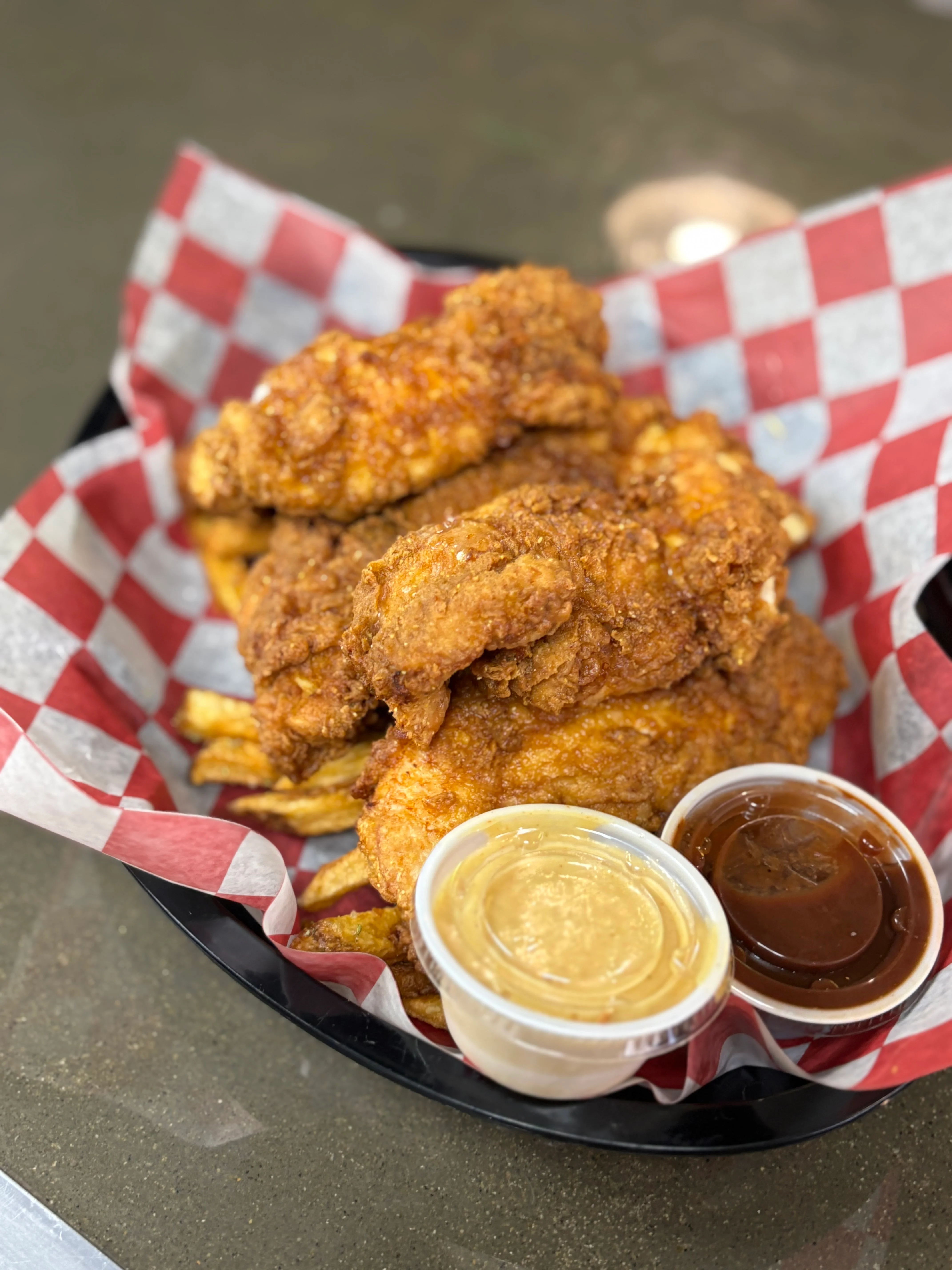 Southern fried chicken with fries and dipping sauces
