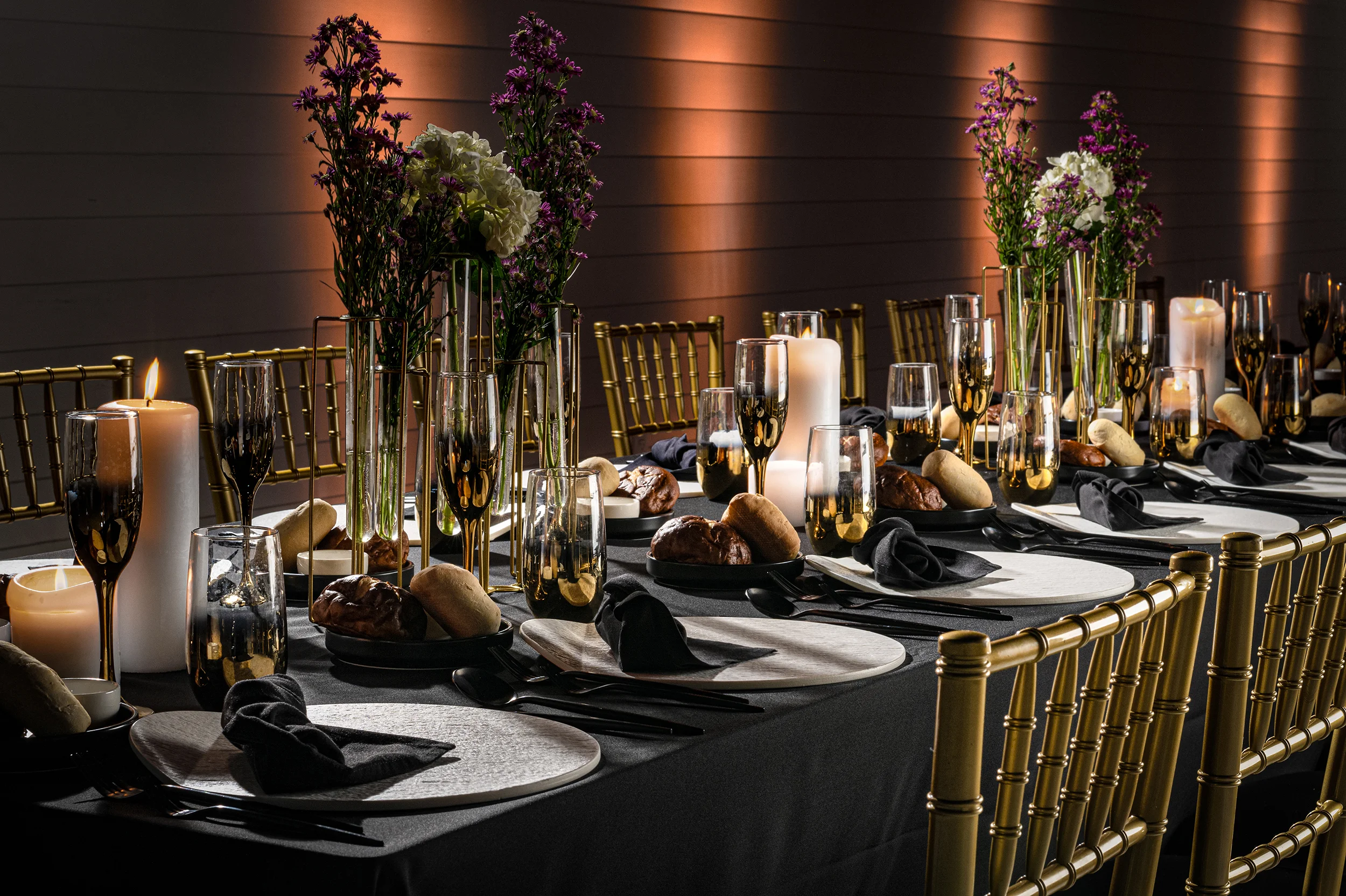 Elegant dining setup with floral centerpieces and candlelight