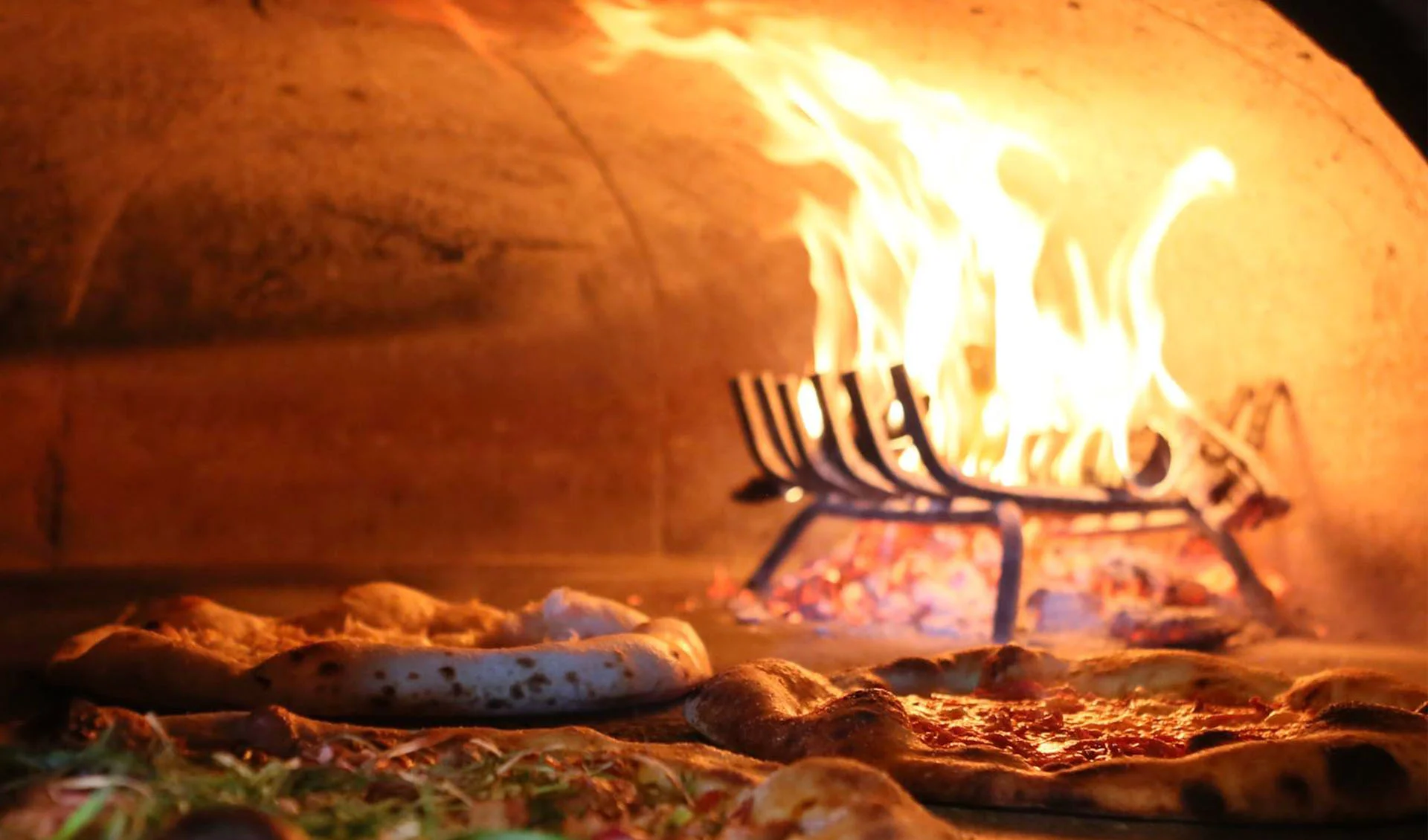 close up of pizzas in the pizza oven