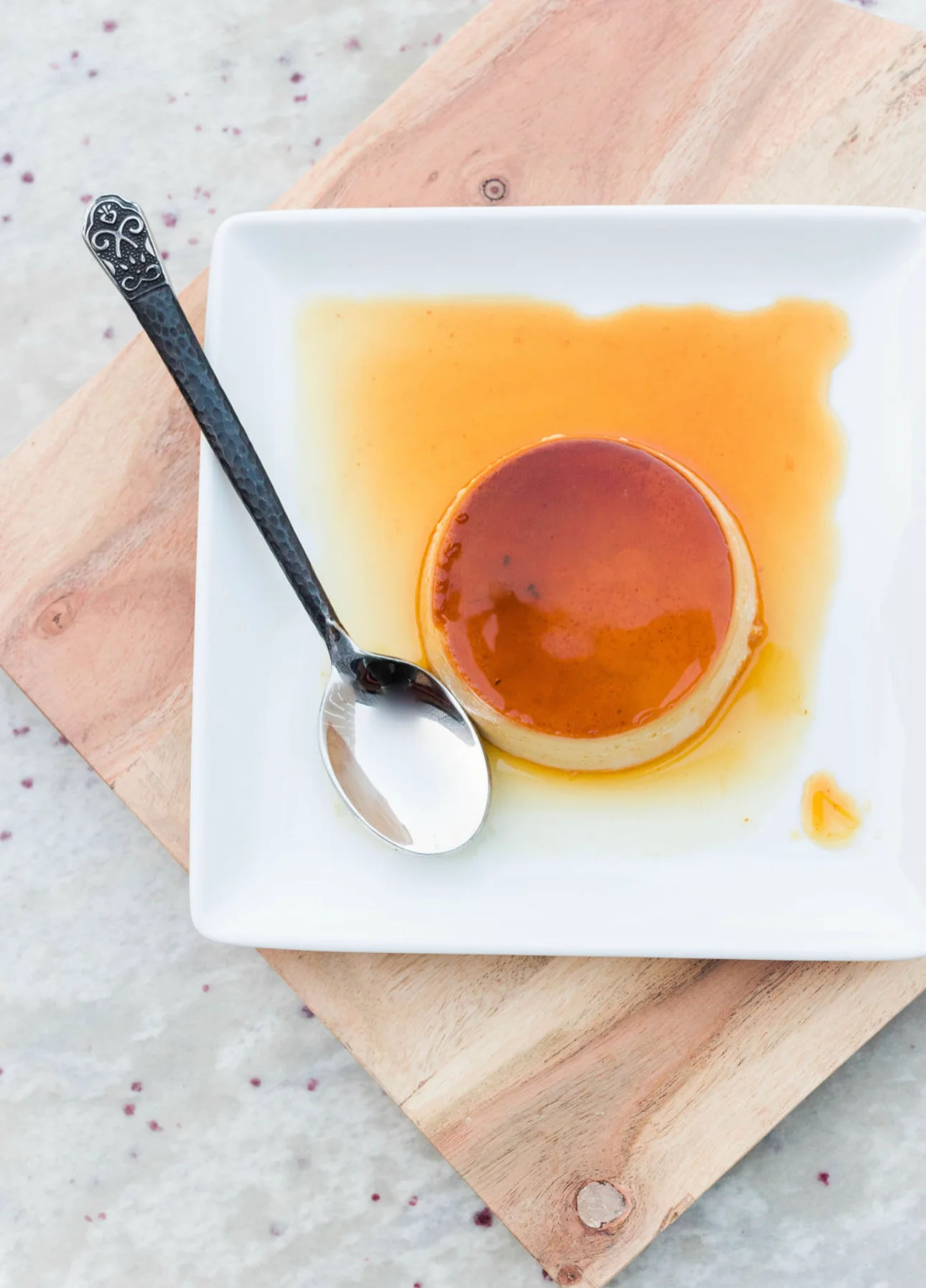 Classic flan dessert with caramel sauce on a white plate