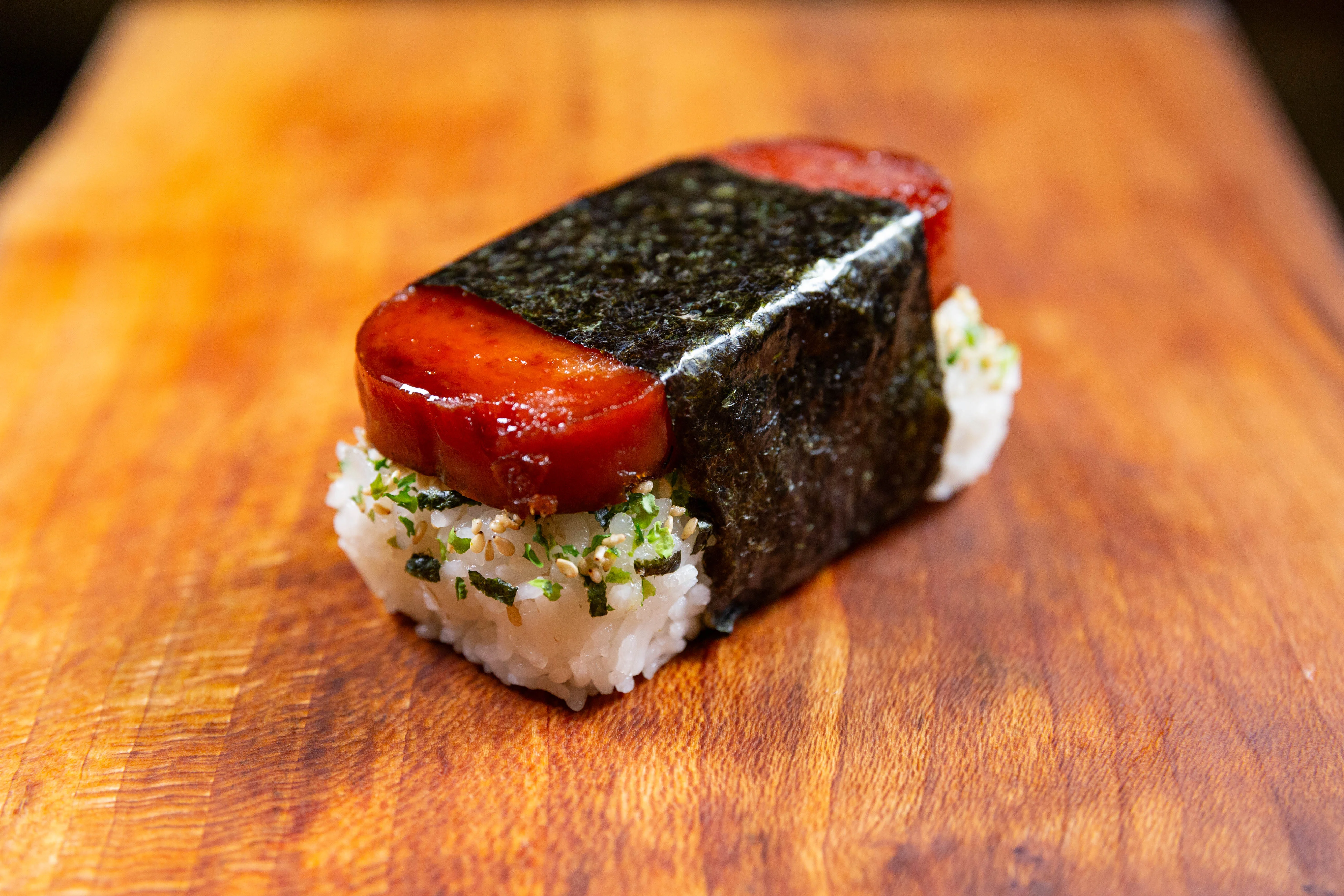 Hawaiian spam musubi on a wooden board