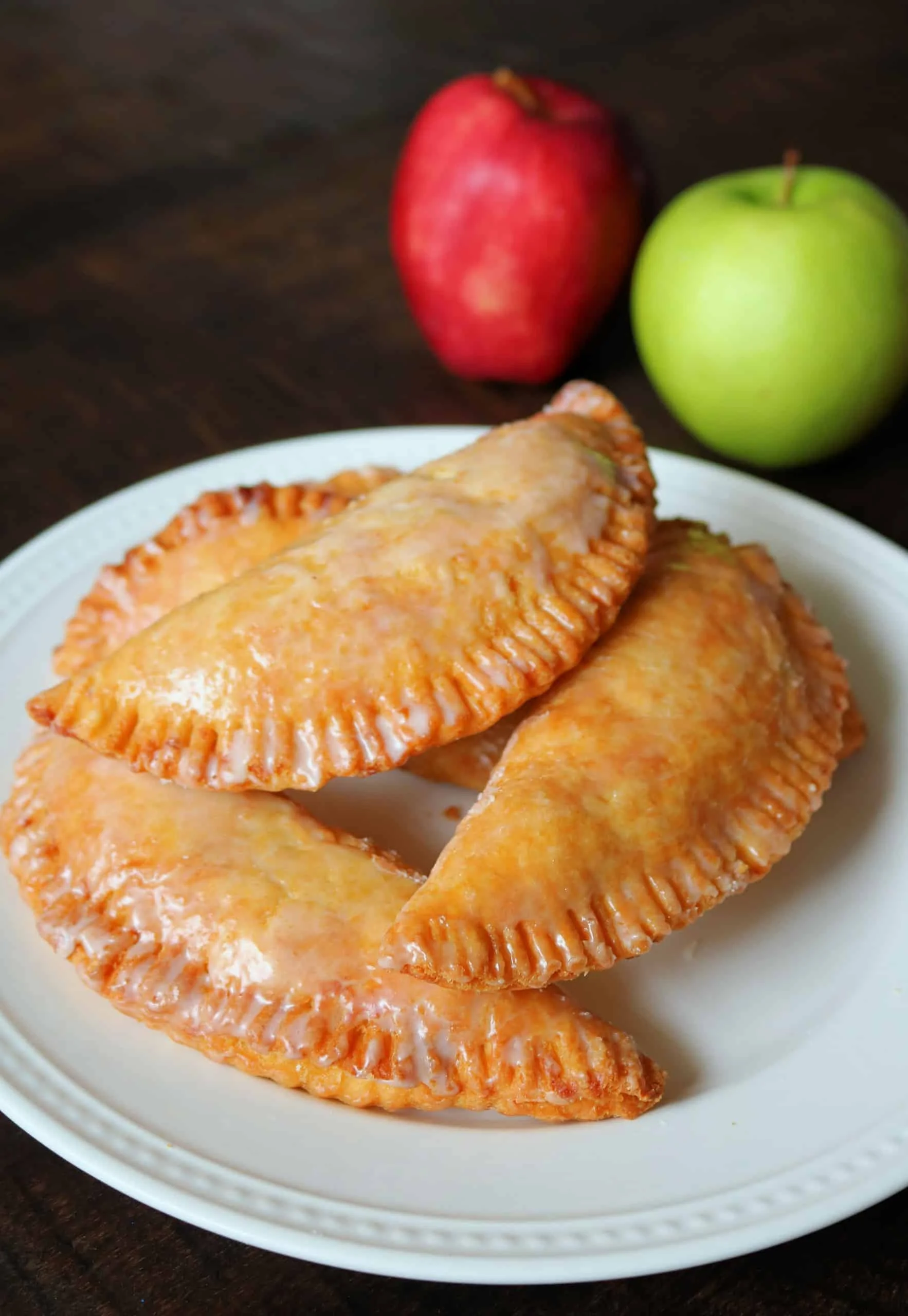 Golden apple turnovers on a white plate