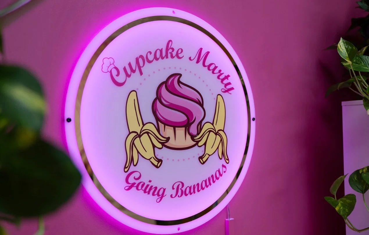 Colorful neon sign for Cupcake Marty bakery