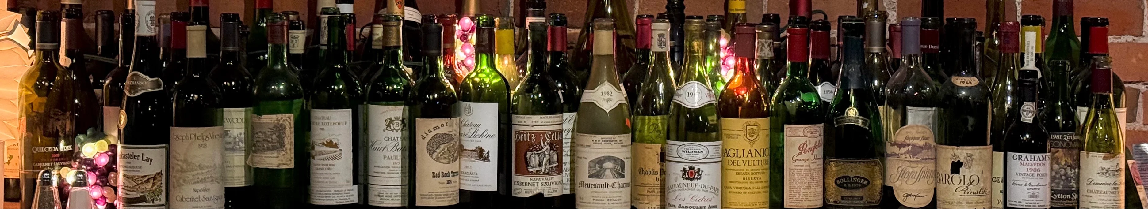 Collection of fine wines displayed on a bar shelf
