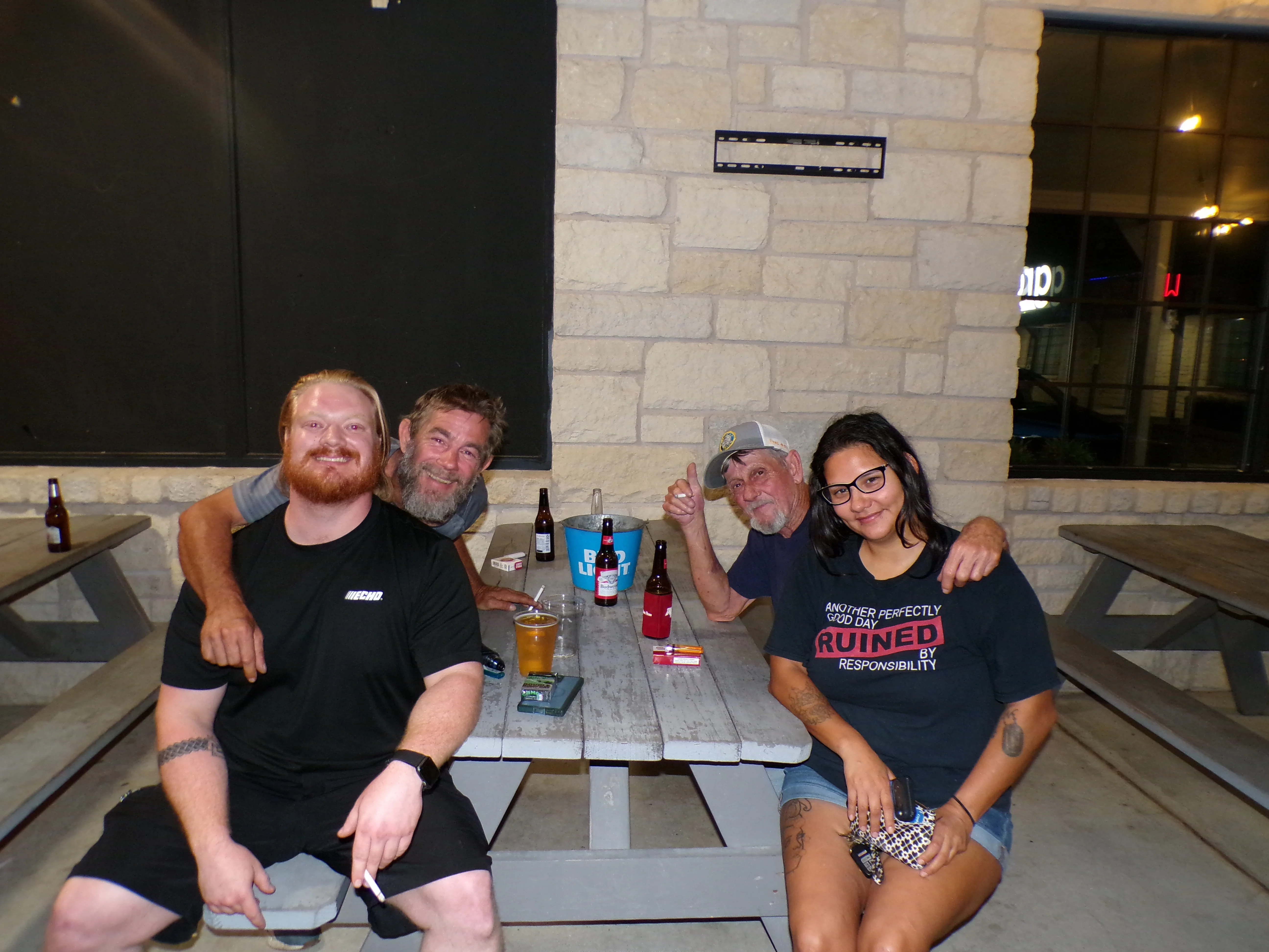 Group of friends enjoying drinks at a casual outdoor setting
