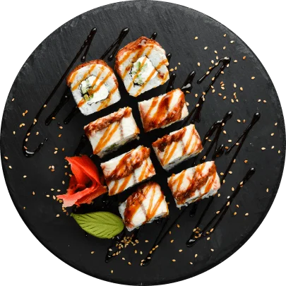 Japanese sushi rolls drizzled with sauce on a black plate