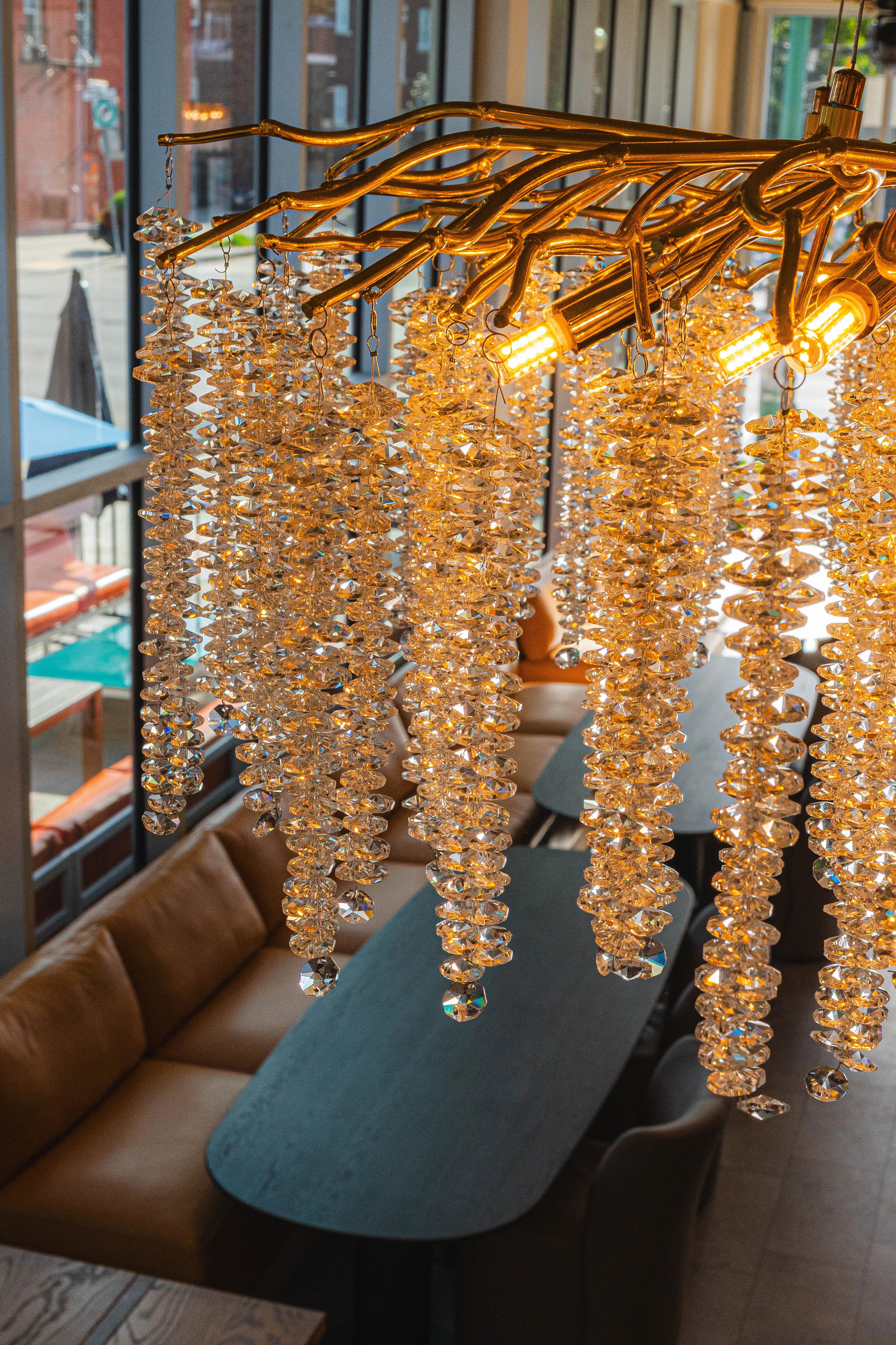 Elegant chandelier with crystal accents illuminating a modern restaurant interior