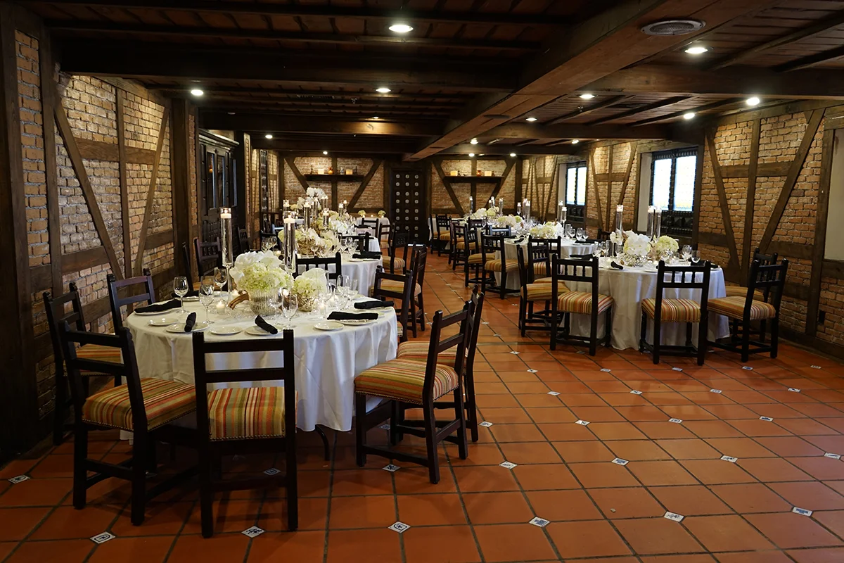 Private dining room at Casa Juancho set up for events, featuring warm Spanish décor and elegant table settings.