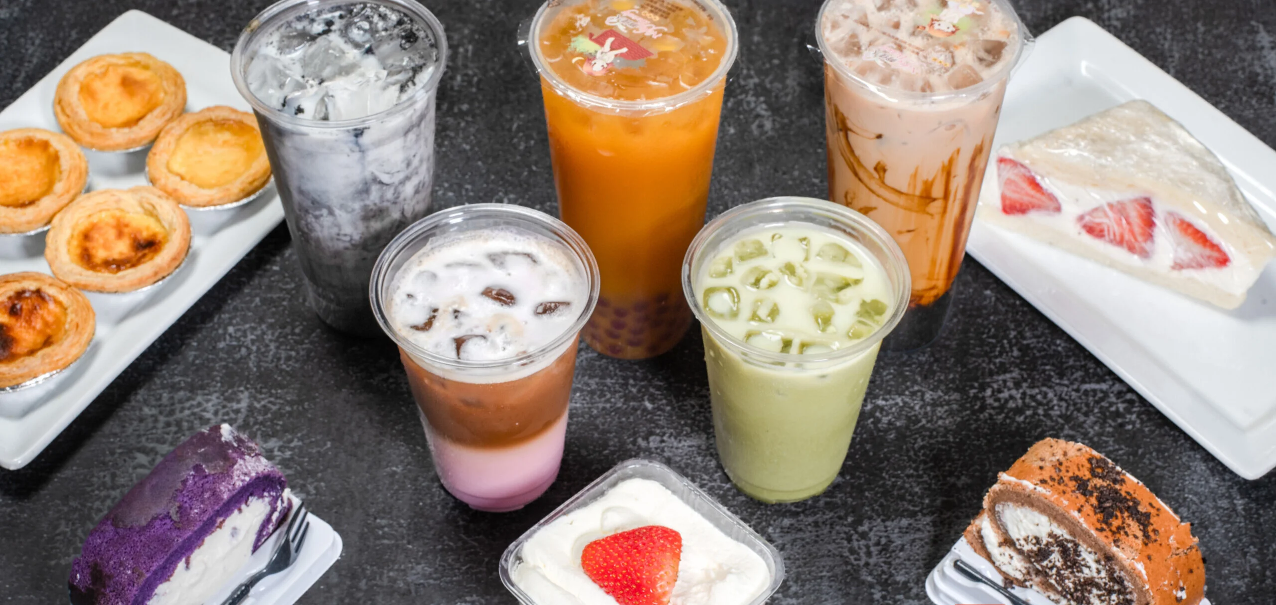 Hero Photo of each boba tea and coffee and baked good item. Including Ube, pumpkin, Strawberry, milk teas, fruit tea, fruit sandwich, matcha, lattes, sakura, vanilla latte, cakes, cake minis, and egg tarts