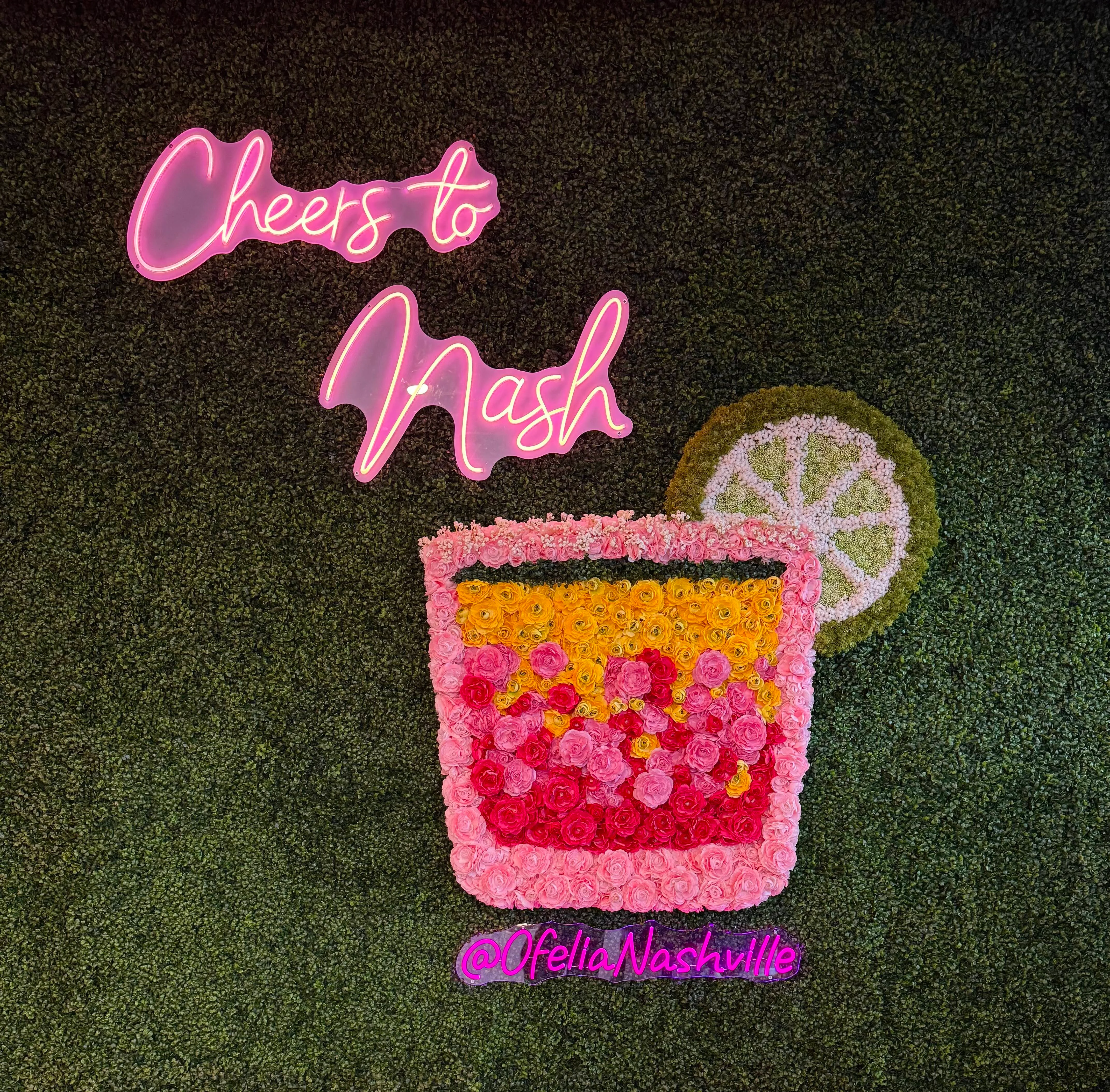 Colorful floral wall art with neon sign in a trendy restaurant