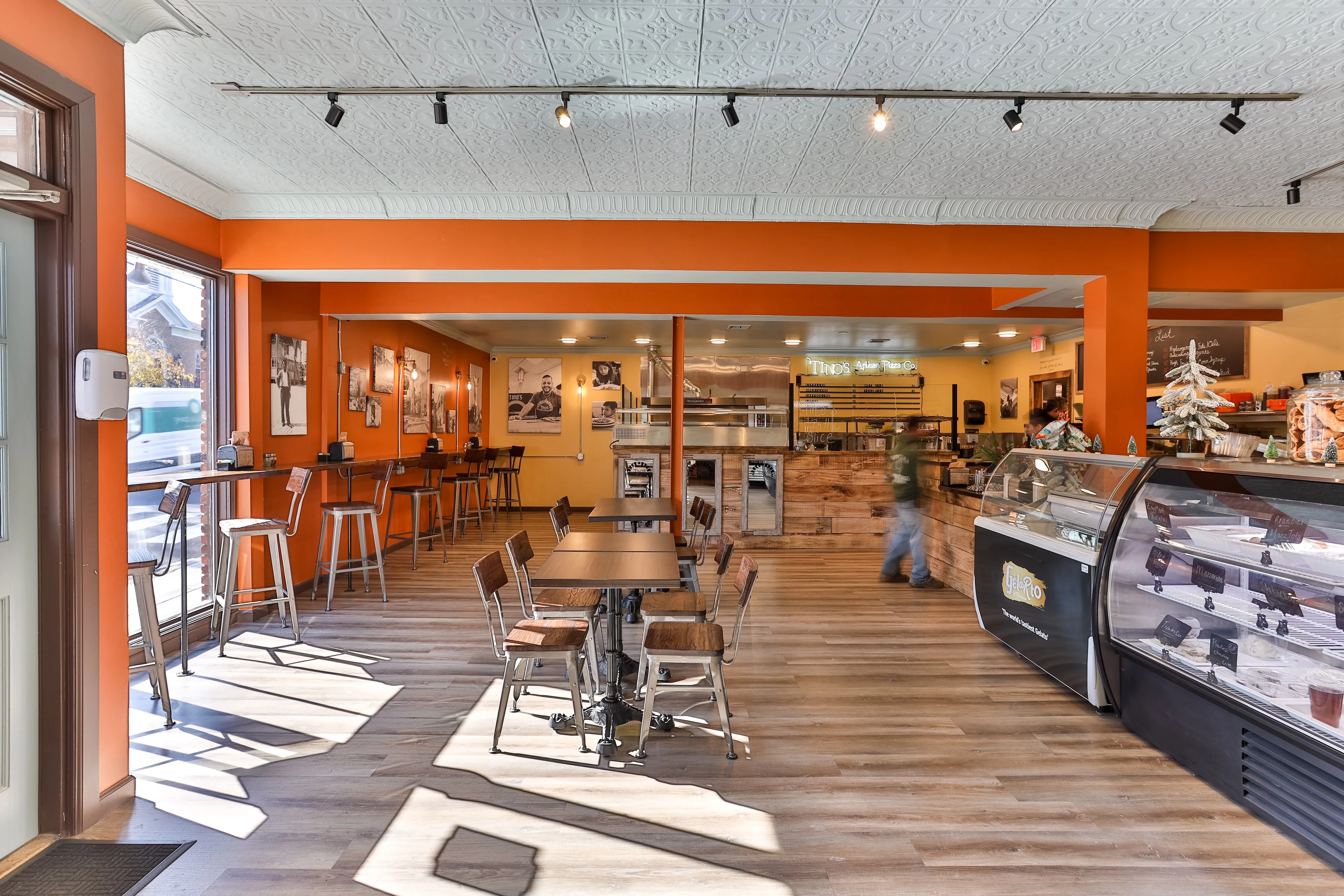 Cozy restaurant interior with orange walls and wooden furniture