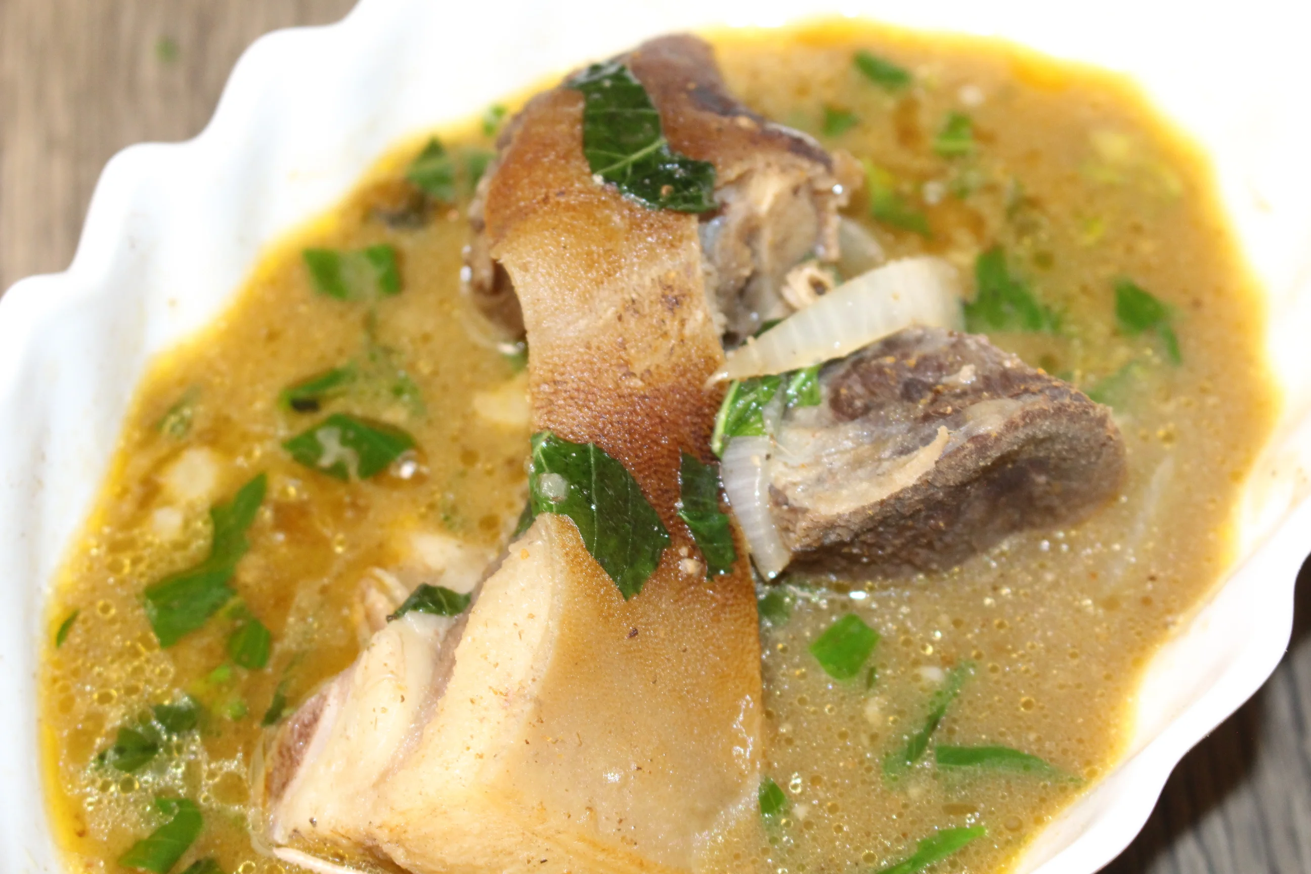 Nigerian oxtail pepper soup with herbs