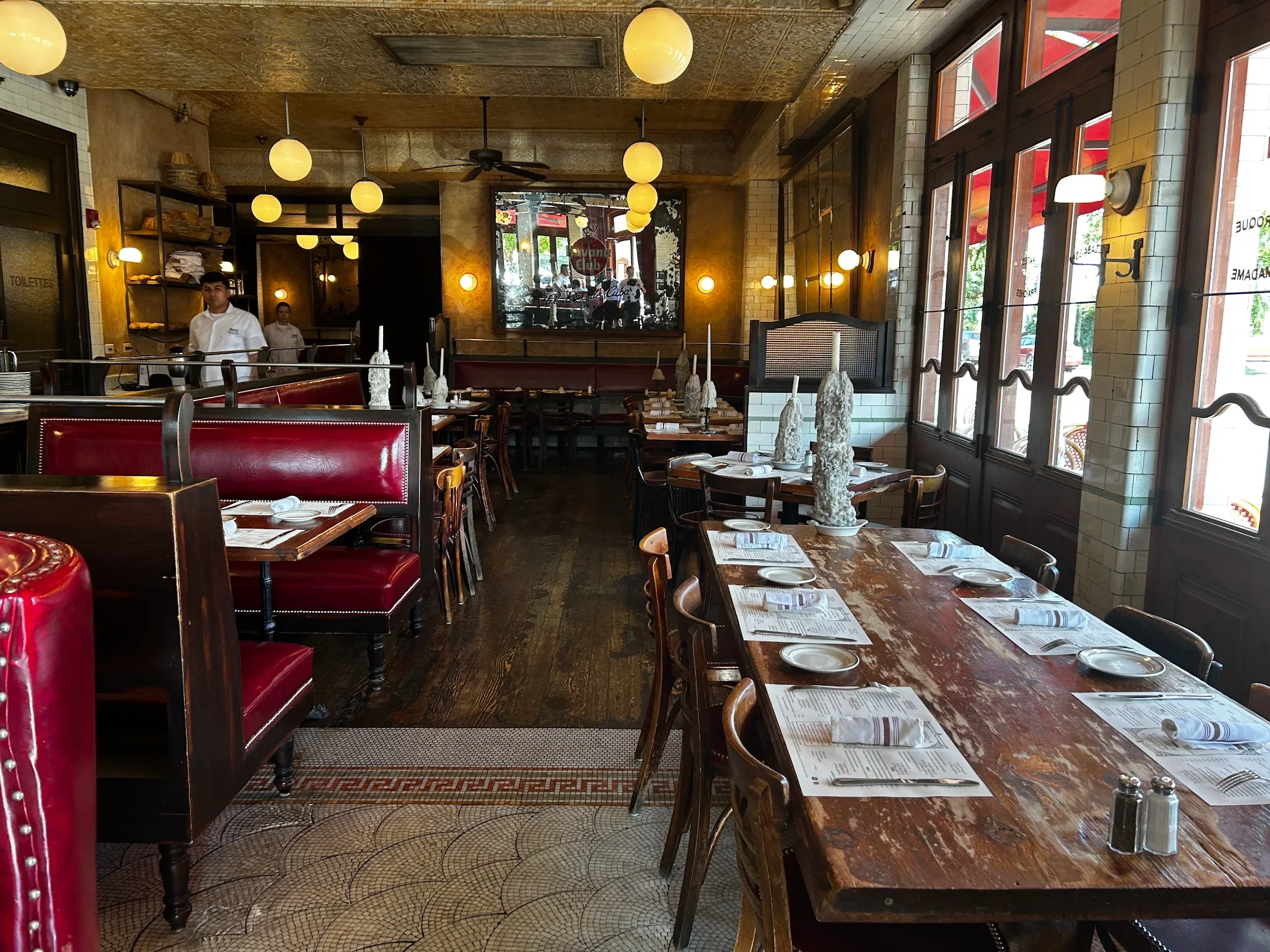 Charming restaurant interior with red booths and wooden tables