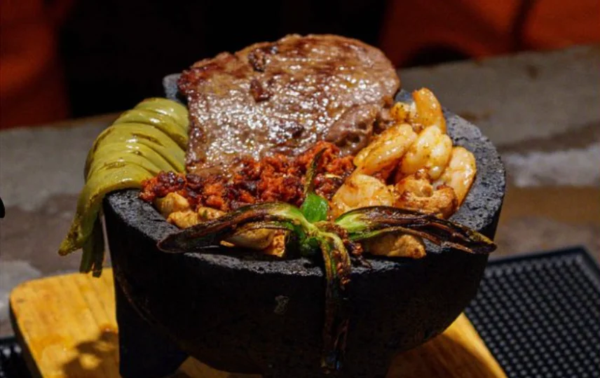 Sizzling Mexican fajitas served in a stone bowl