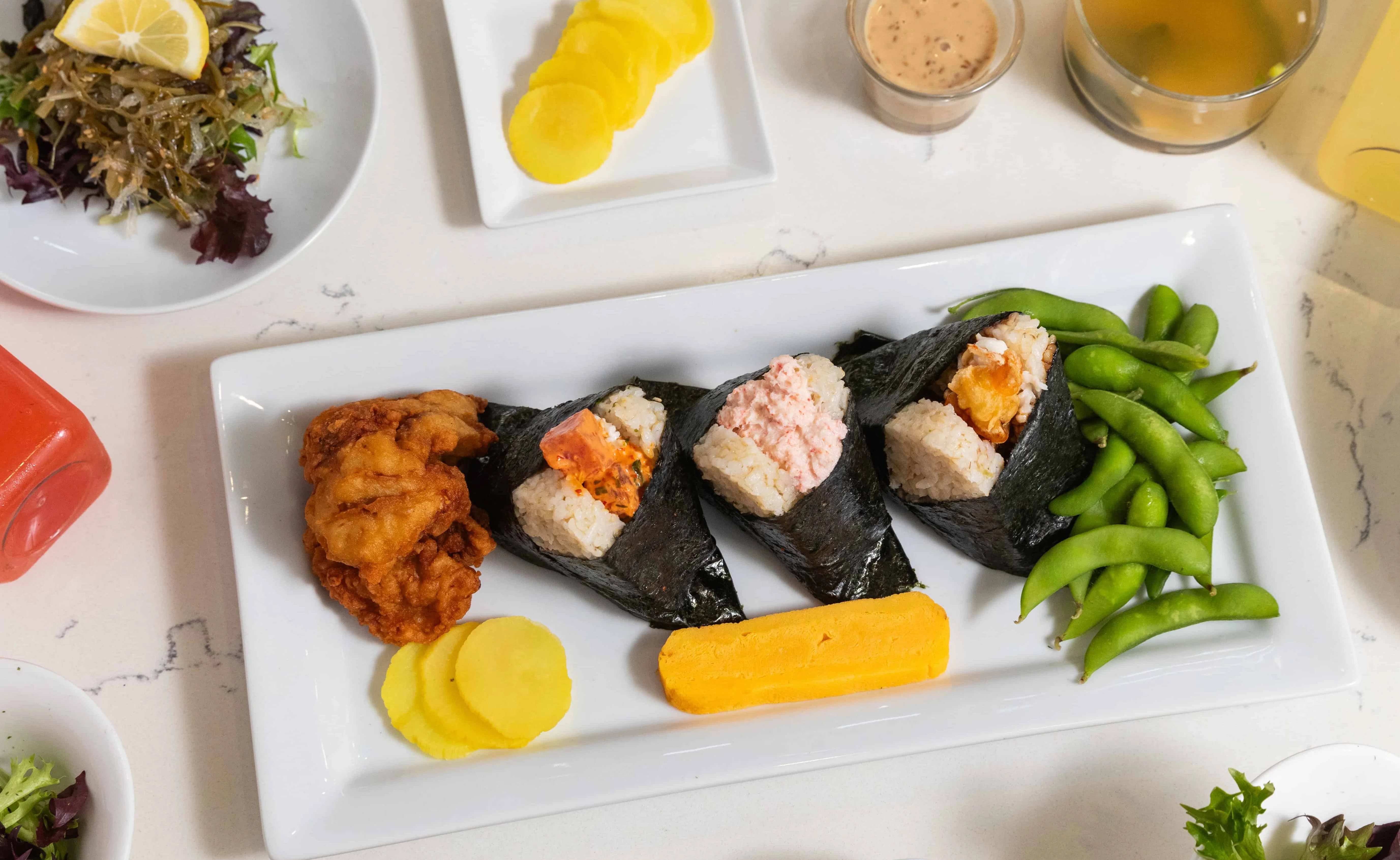 Japanese onigiri platter with fried chicken and edamame