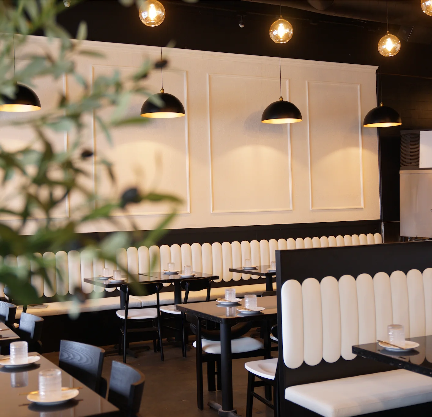 Modern restaurant interior with stylish seating and pendant lighting