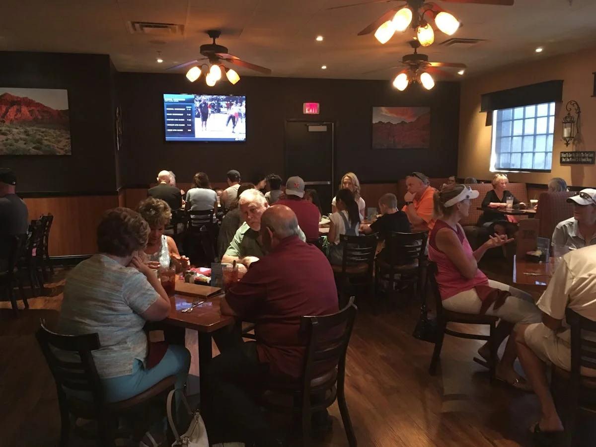 Cozy restaurant interior with diners enjoying meals and warm lighting