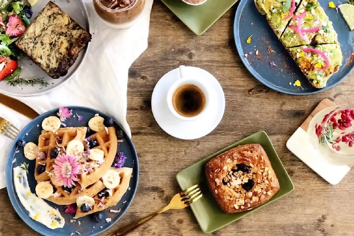 Colorful brunch spread featuring waffles and avocado toast