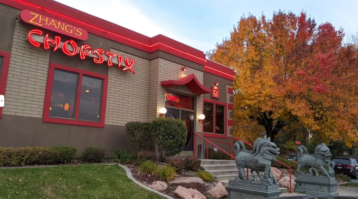 Exterior view of Zhang's Chopstix restaurant with vibrant autumn foliage