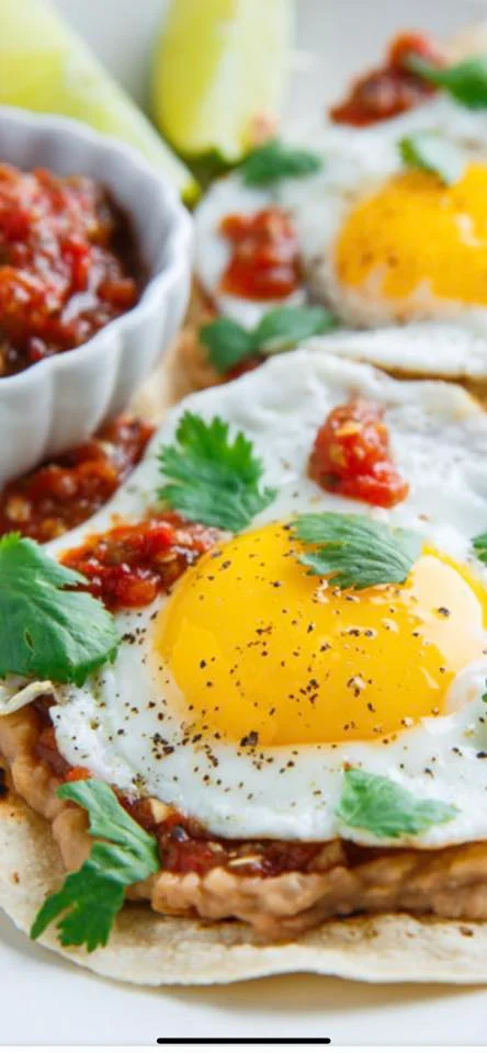 Huevos rancheros with fried eggs and salsa on tortillas