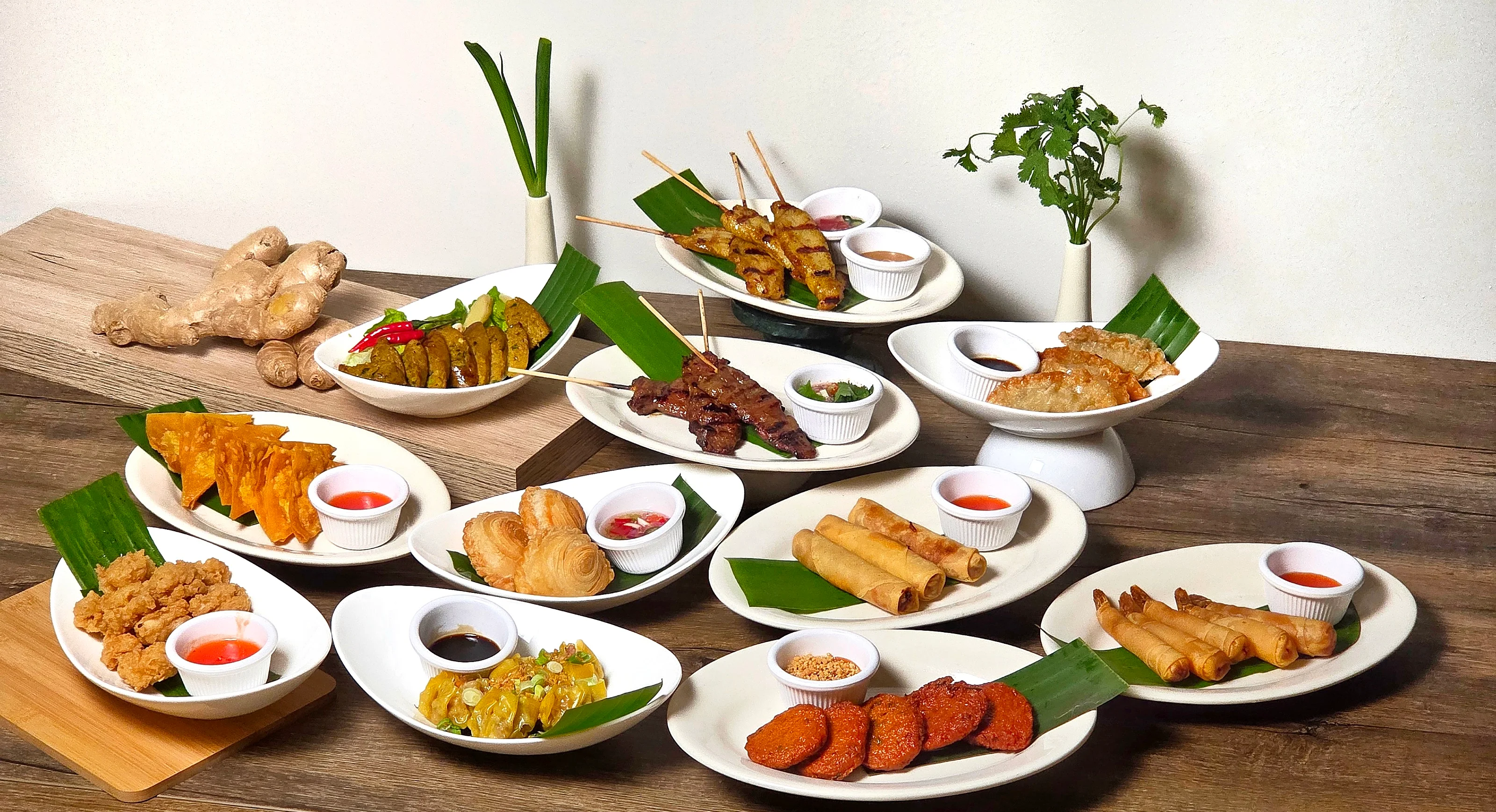 Assorted Southeast Asian appetizers including satay and spring rolls