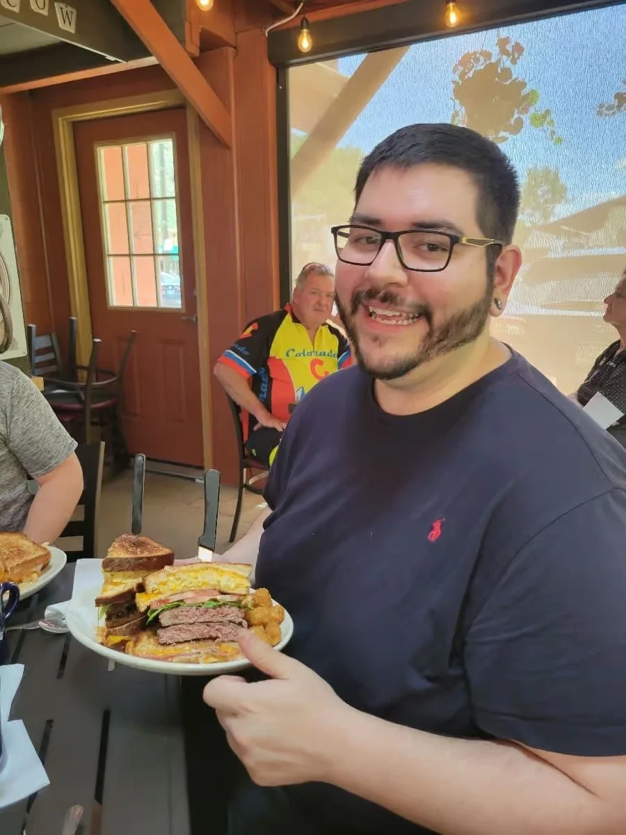 Stacked cheeseburger with crispy sides in a casual dining setting