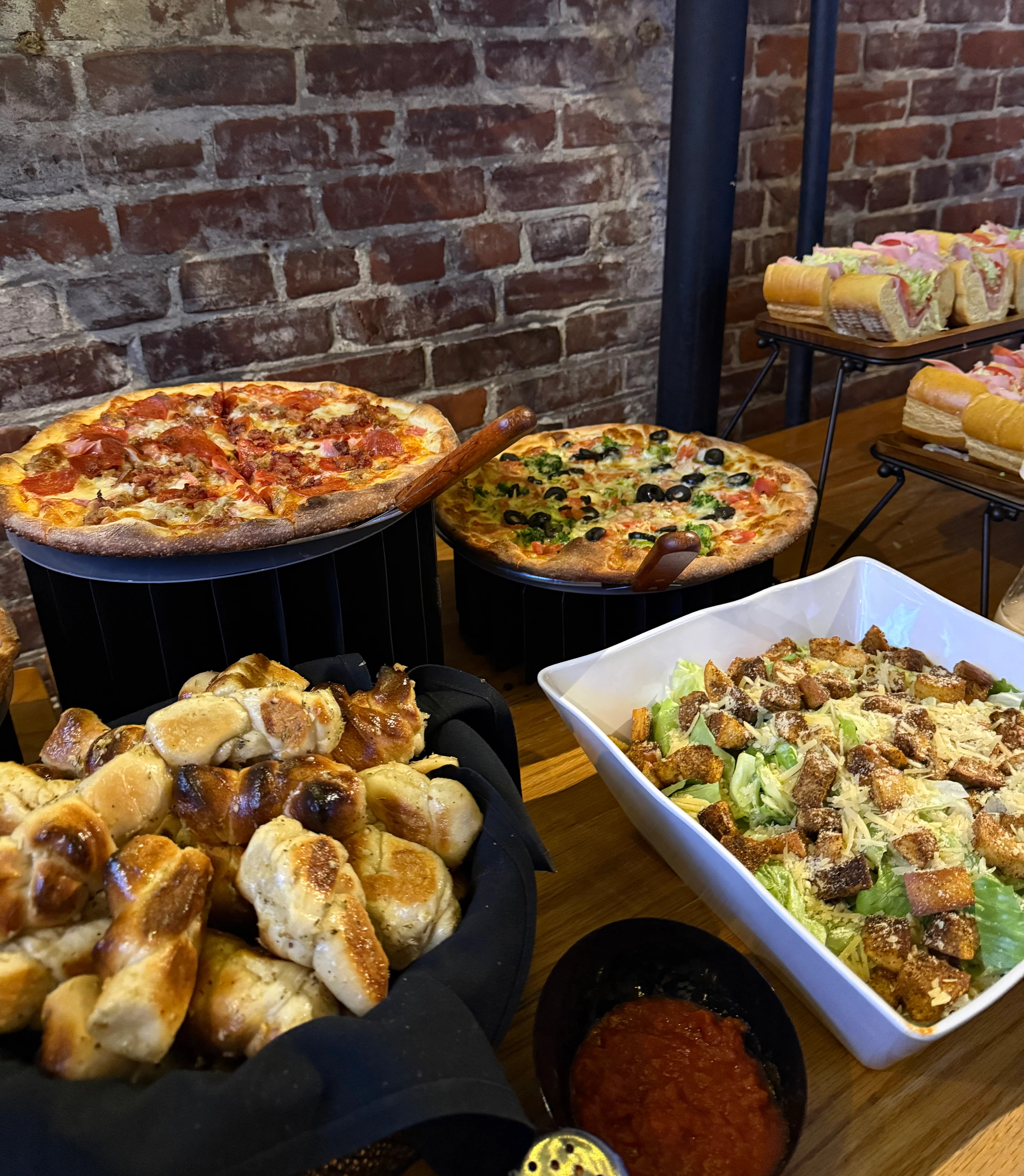 Assorted pizzas and pretzel bites in a cozy restaurant setting