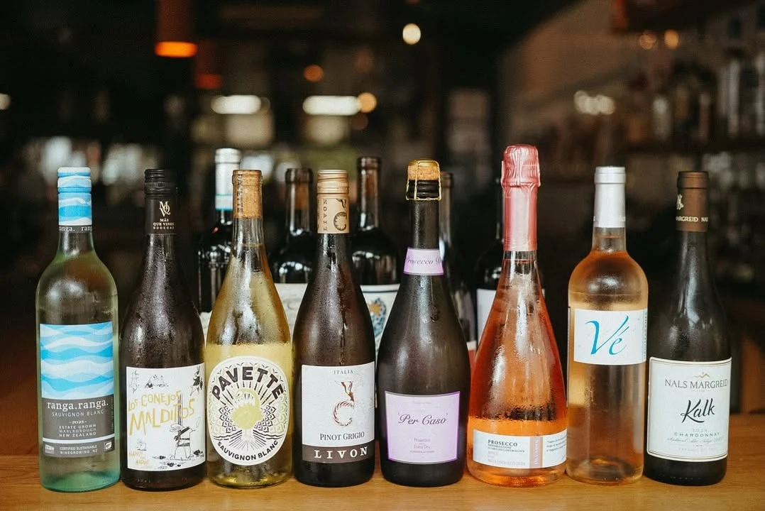 Selection of diverse wines displayed on a wooden bar