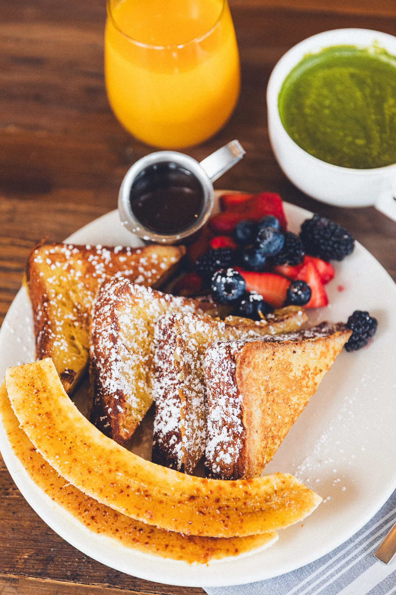 Delicious French toast served with fresh berries and orange juice