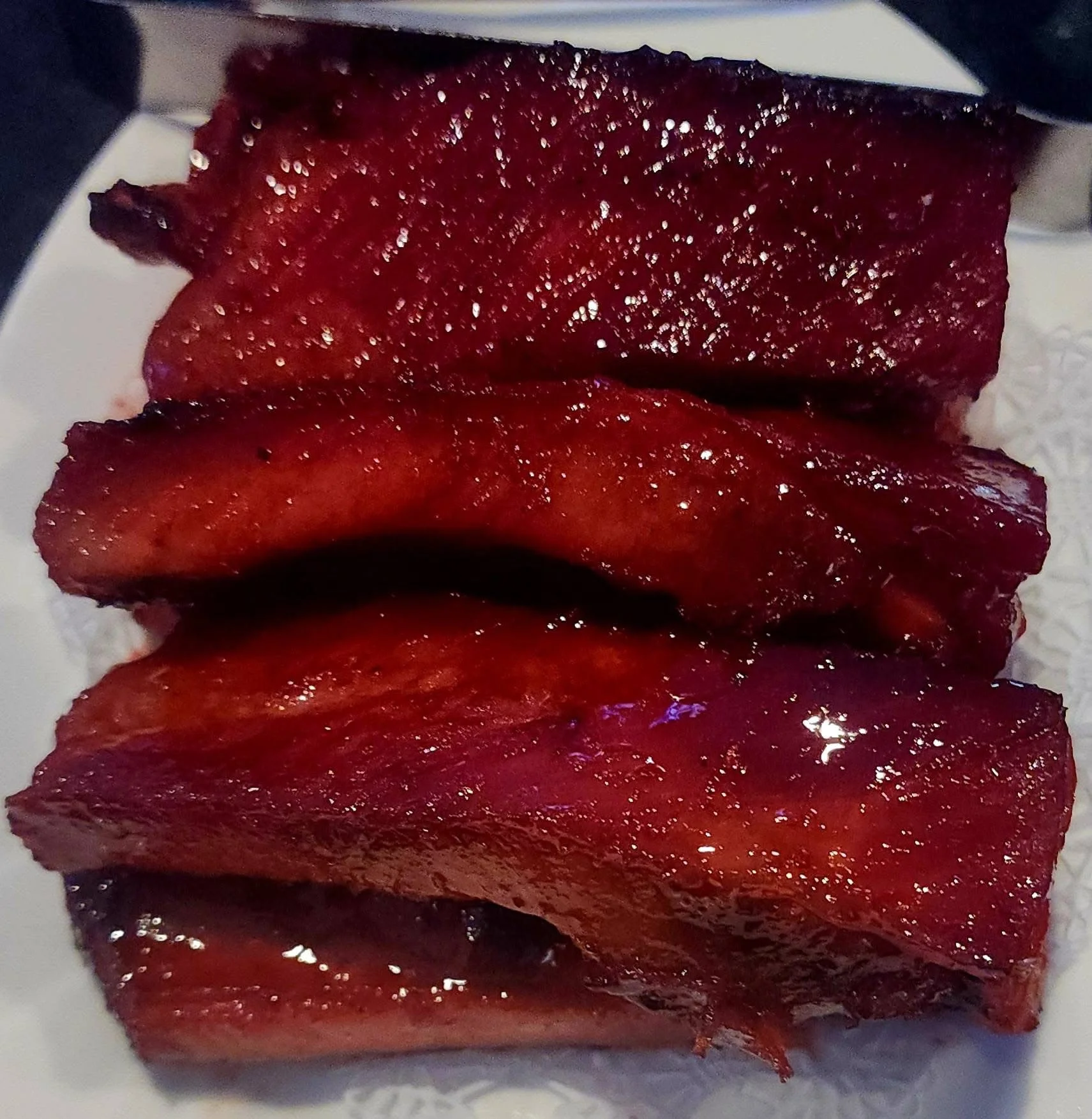 Delicious Chinese char siu pork slices glistening with sauce