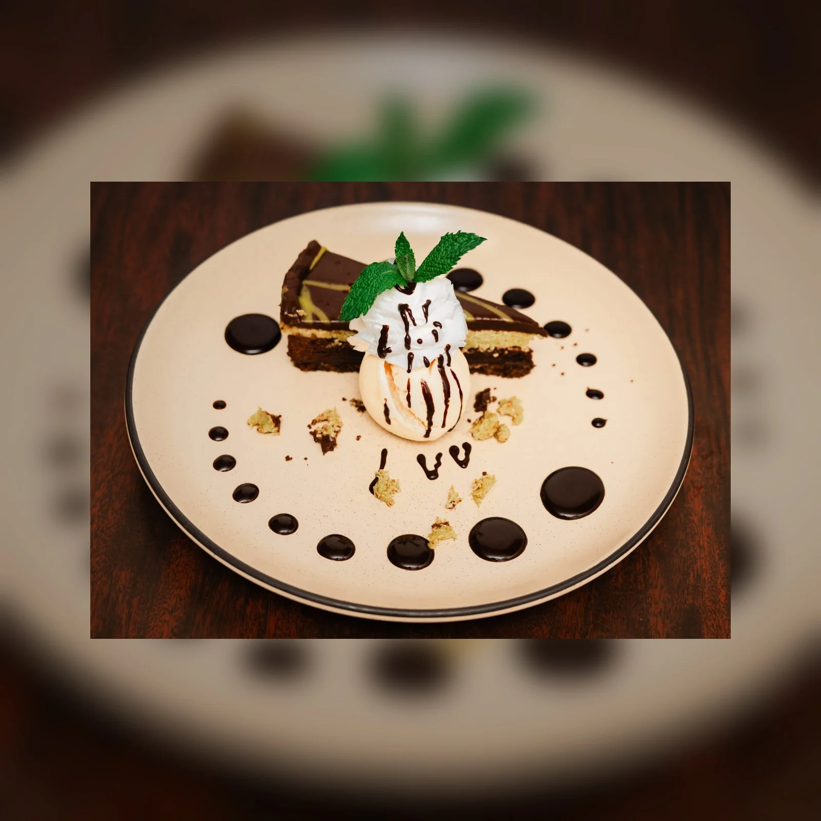 Decadent chocolate cake slice with ice cream and chocolate drizzle