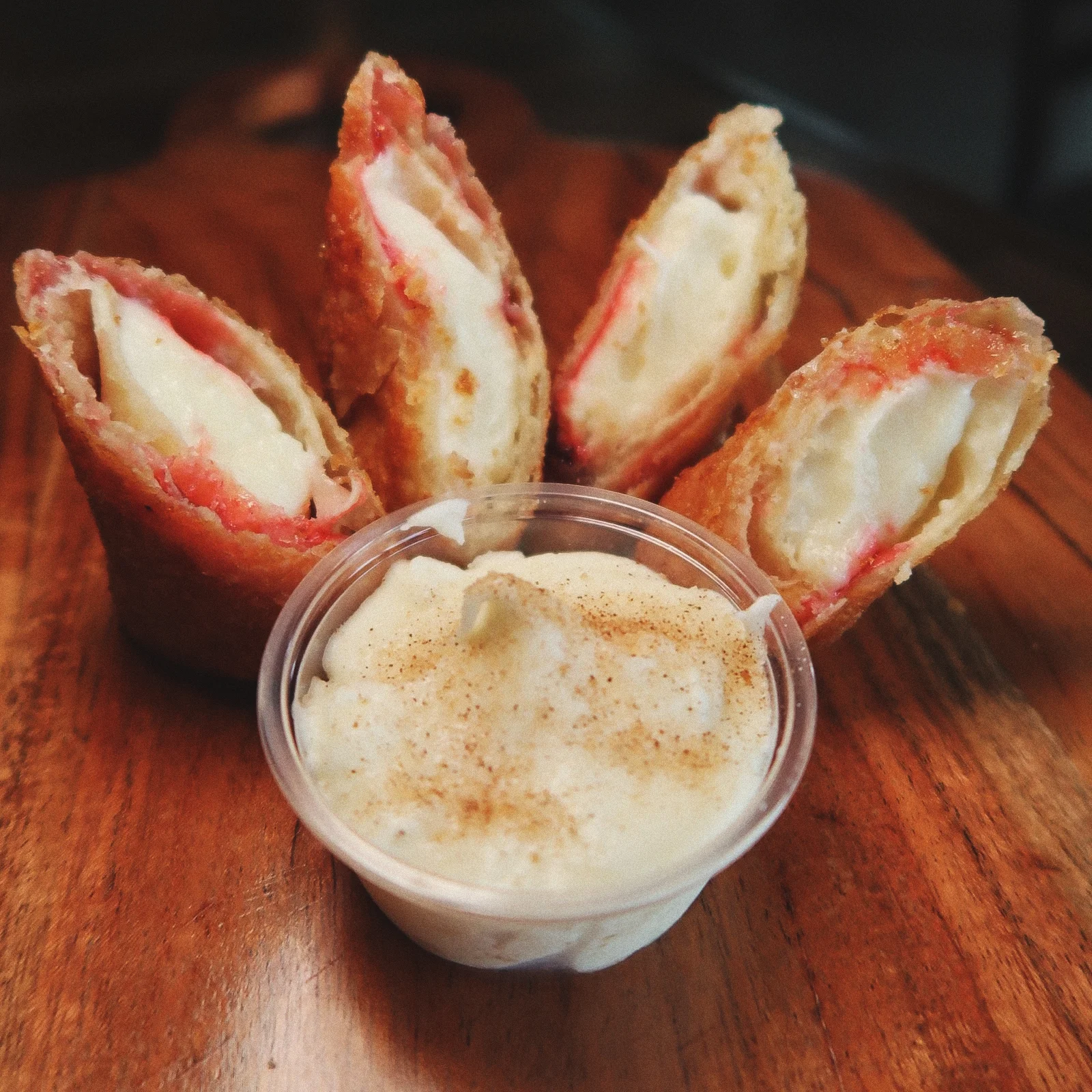 Crispy fried cheesecake egg rolls with sweet dipping sauce