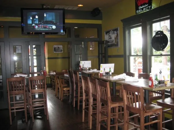 Cozy restaurant interior with wooden furniture and a TV