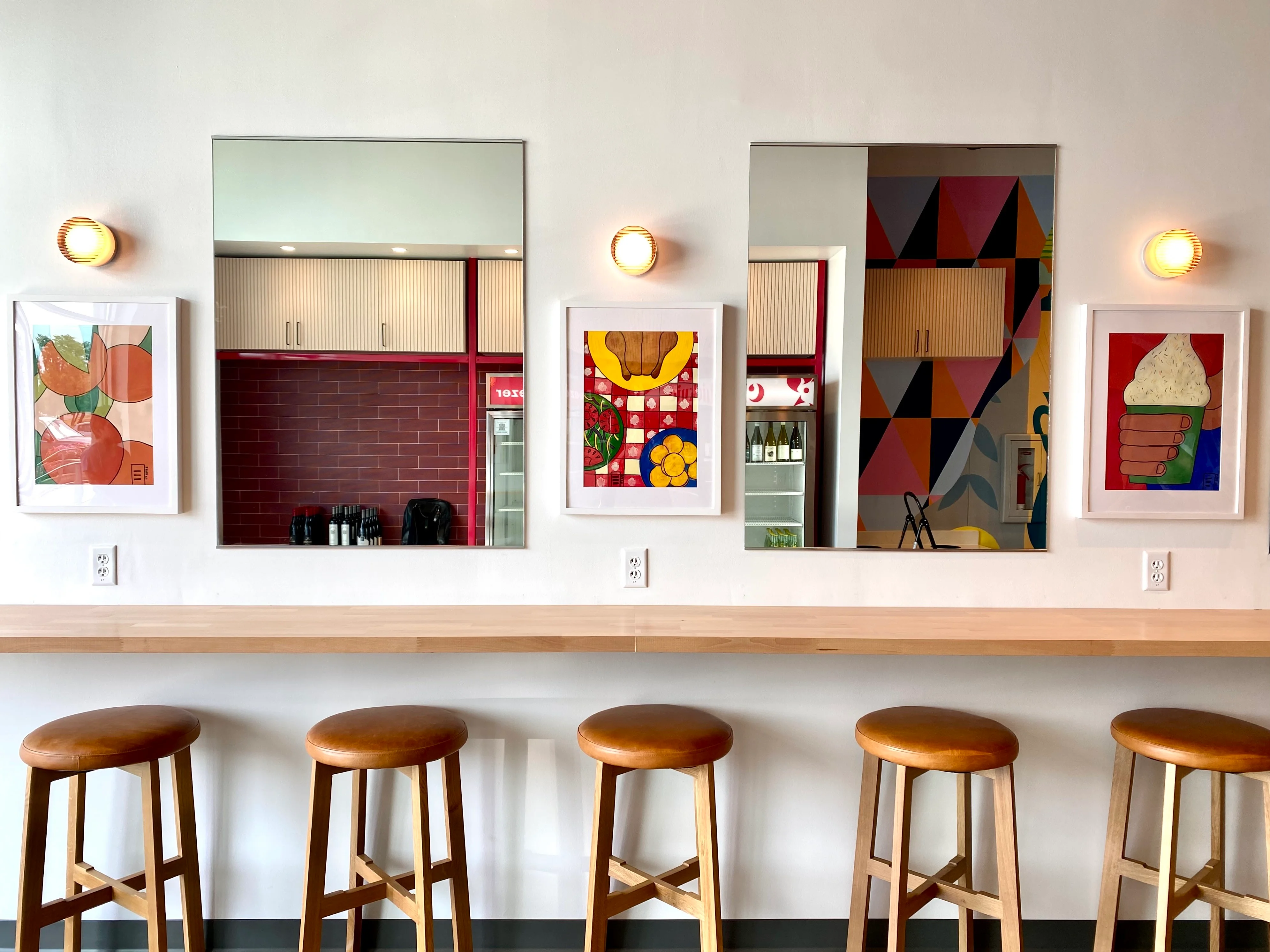 Modern restaurant interior with colorful artwork and bar seating