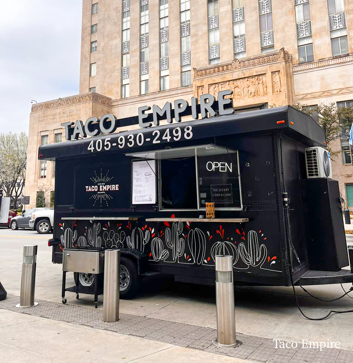 Taco Empire food truck parked in front of a building, open for business.
