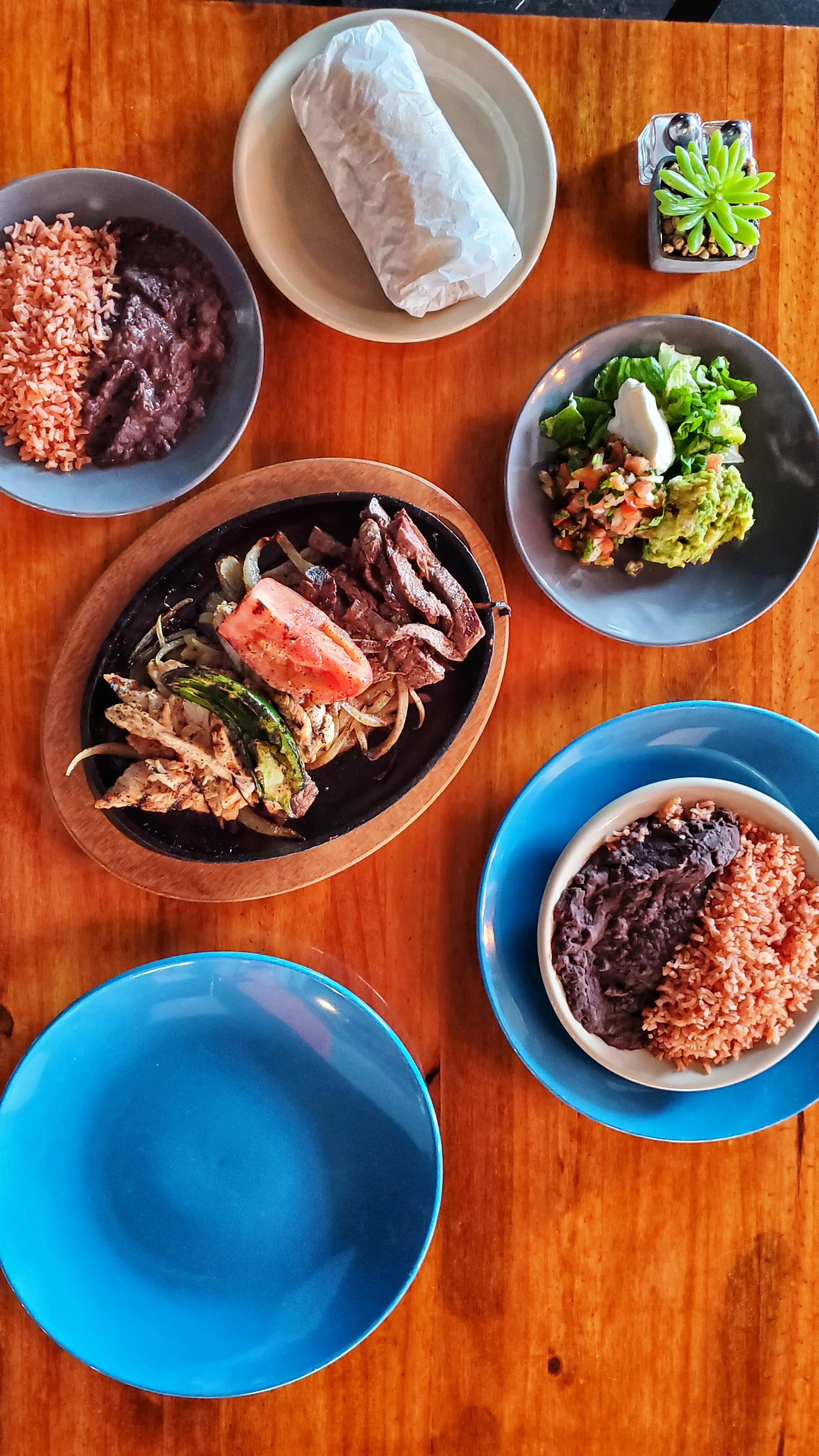 Sizzling fajitas served with rice and beans
