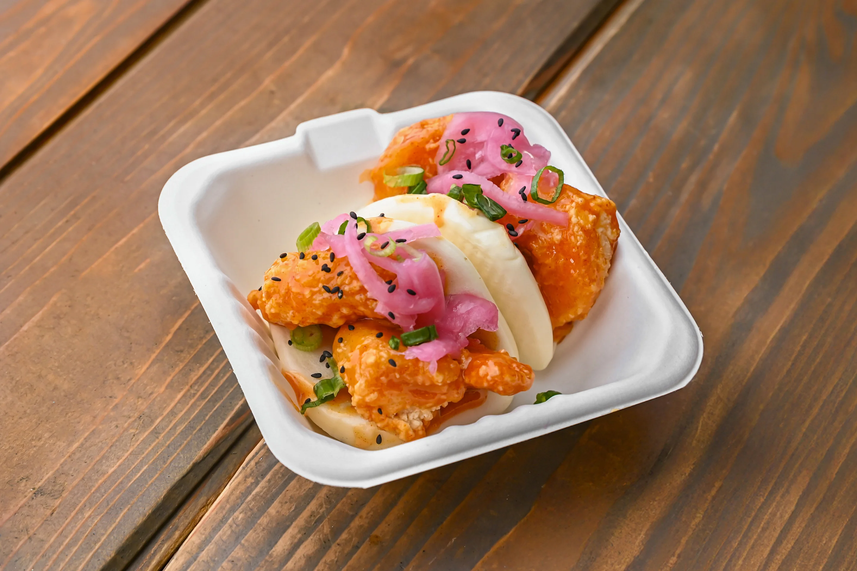 Korean fried chicken bao with pickled onions
