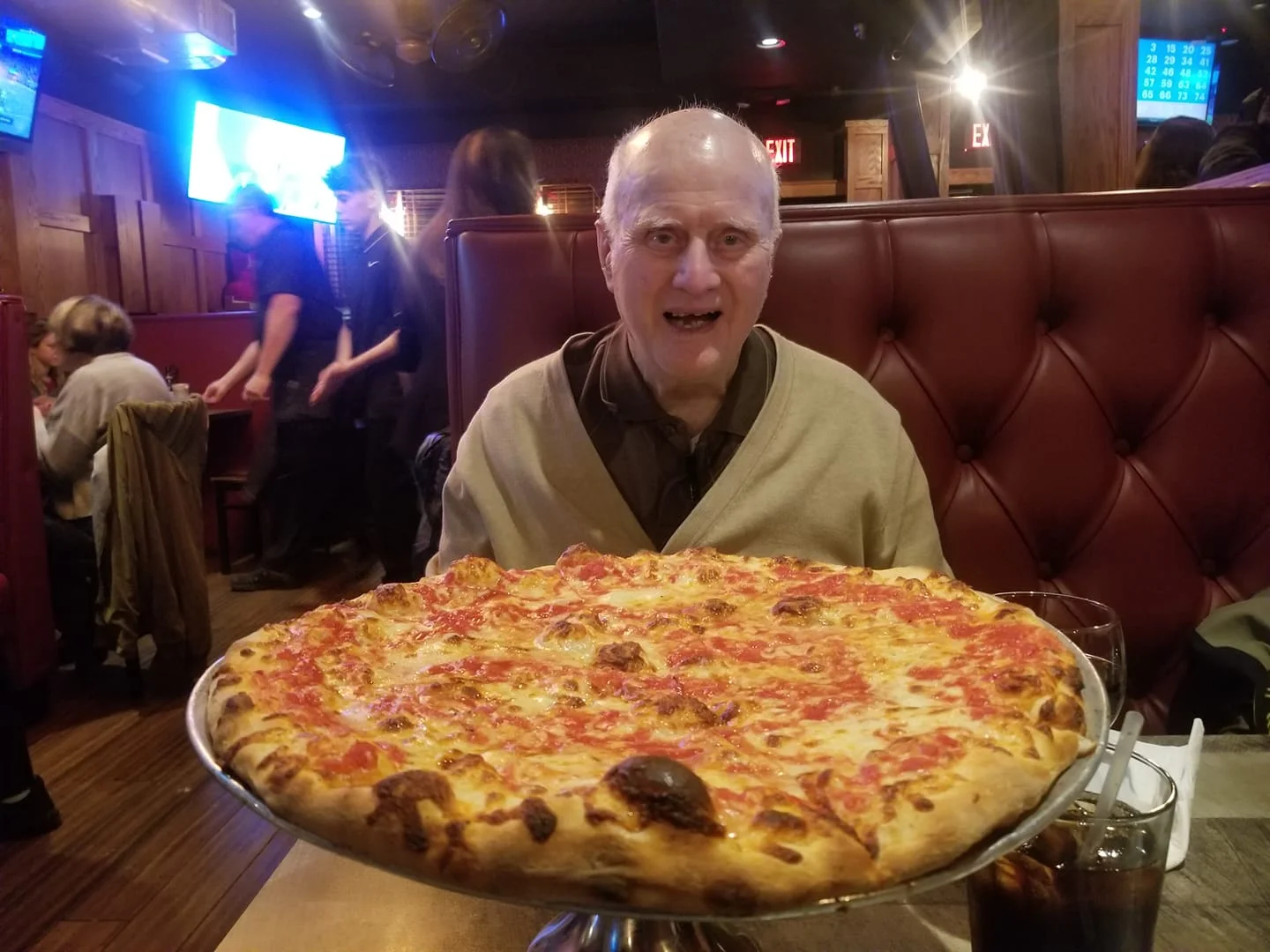 Large Margherita pizza served in a cozy restaurant setting