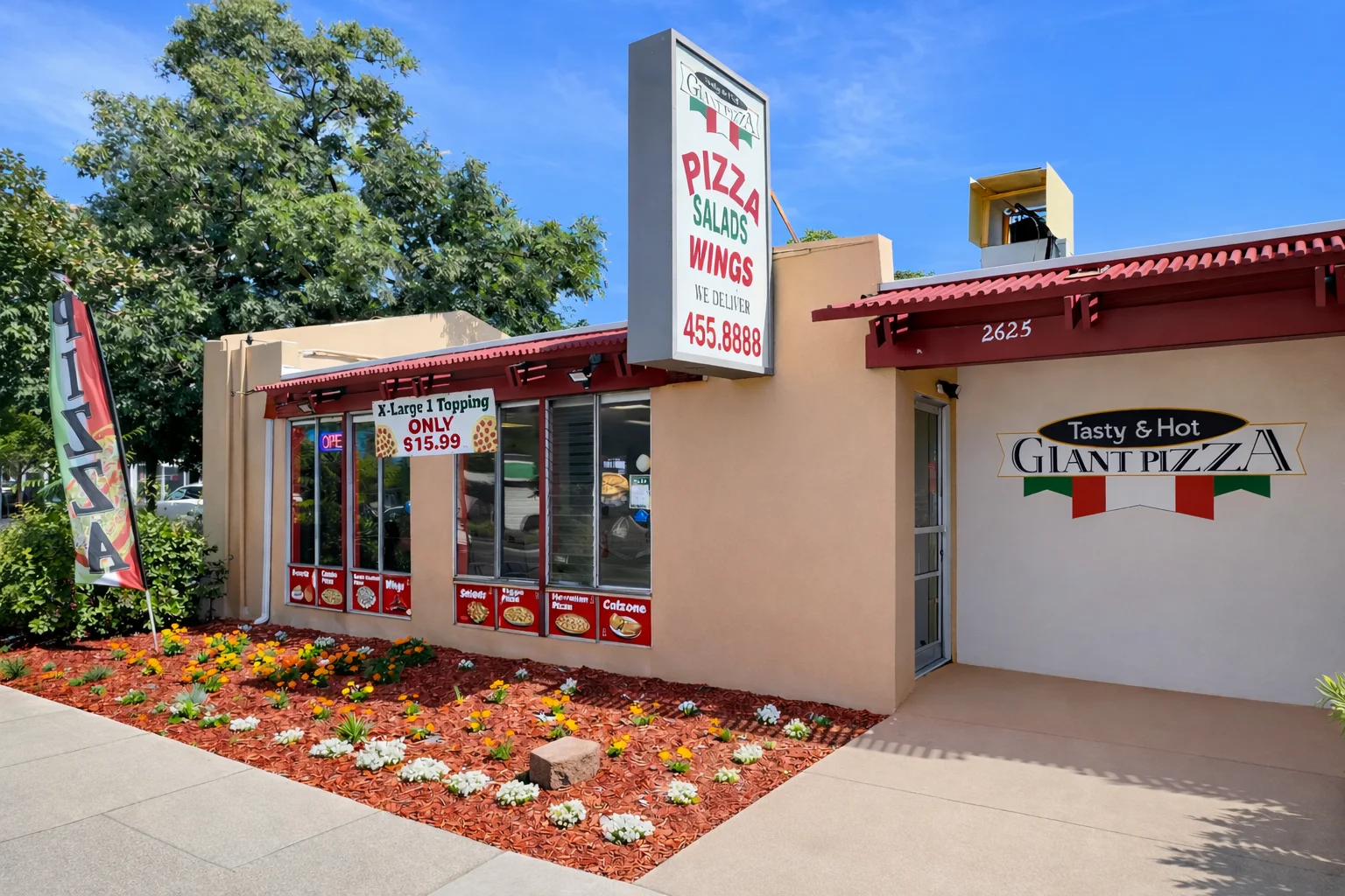 Exterior of a pizza restaurant with vibrant signage and flowers