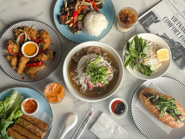 Assorted Vietnamese dishes including pho, spring rolls, and banh mi