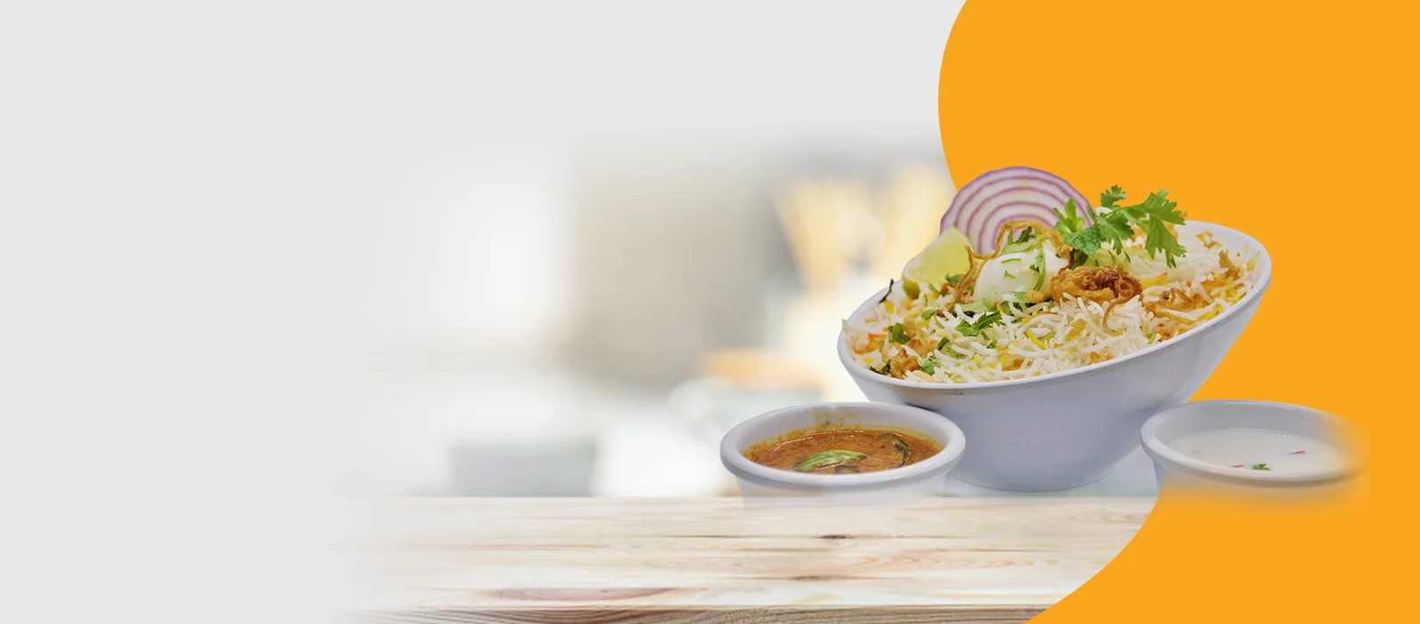 Delicious biryani served with raita and curry